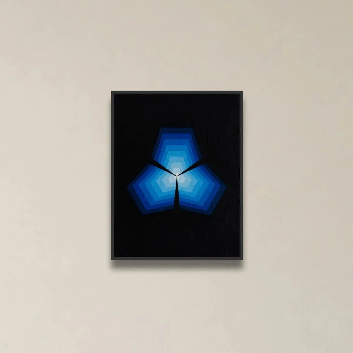 Modern wall clock with segmented blue geometric pattern on black background, mounted on a beige wall.