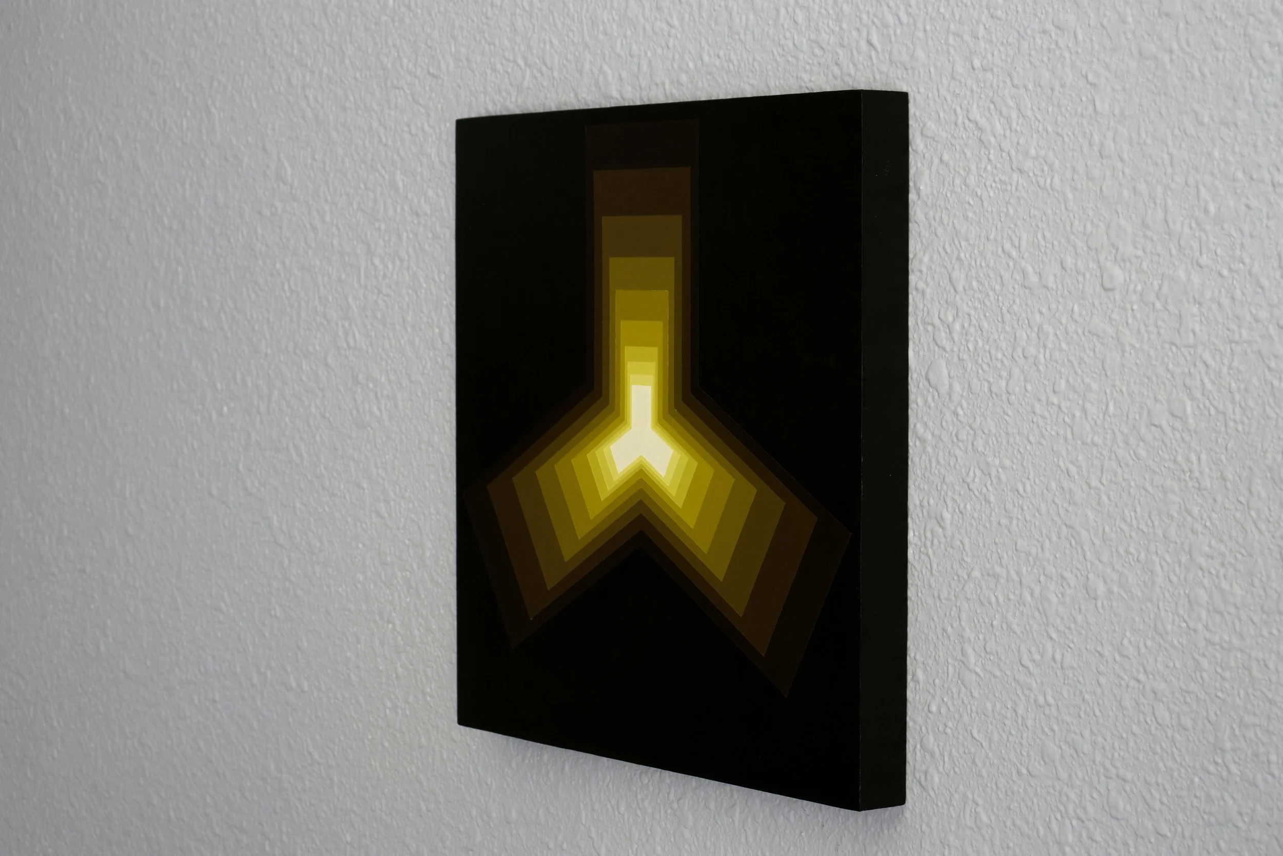 Symmetrical rectangular shapes joined at the center to form a 3-protrusion shape that glows brightly against a dark void background.jpg