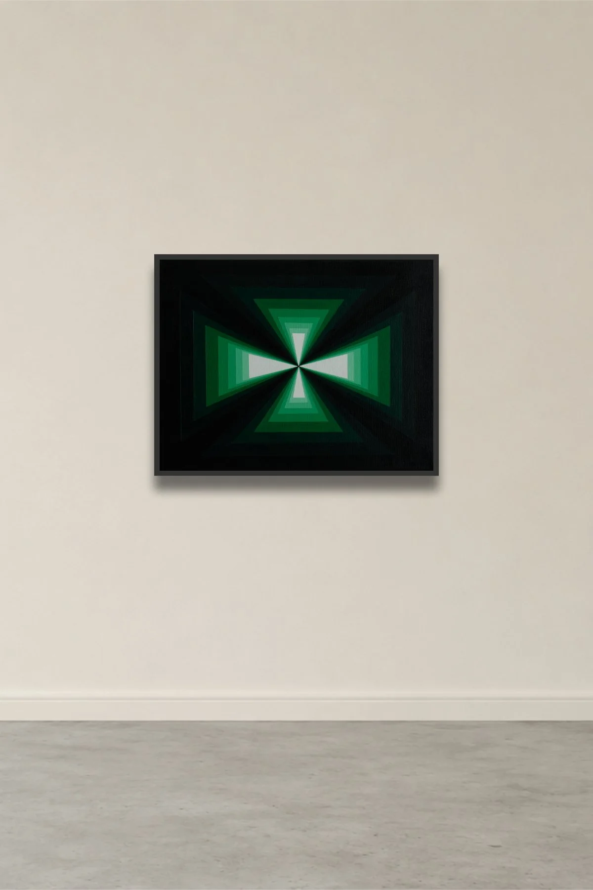 Abstract art with green and white geometric triangular shapes converging towards the center on a black background, framed and hung on a beige gallery wall.