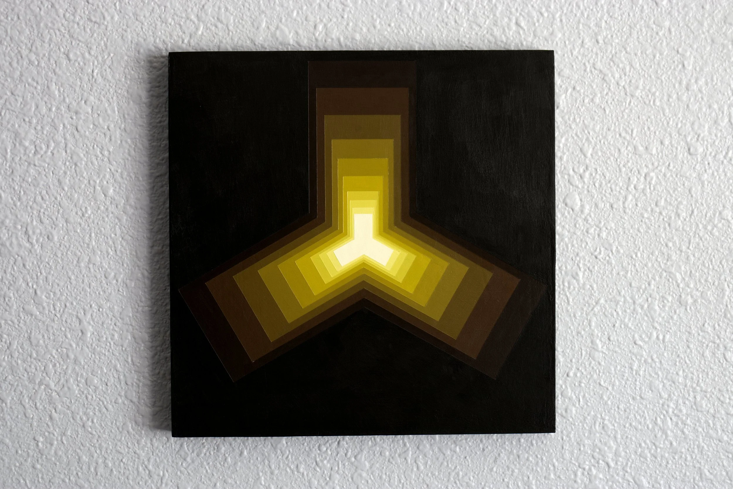 Minimalist yellow abstract painting featuring a hard-edged, molecular-style shape with a gradient from dark amber to a brilliant yellow core.jpg