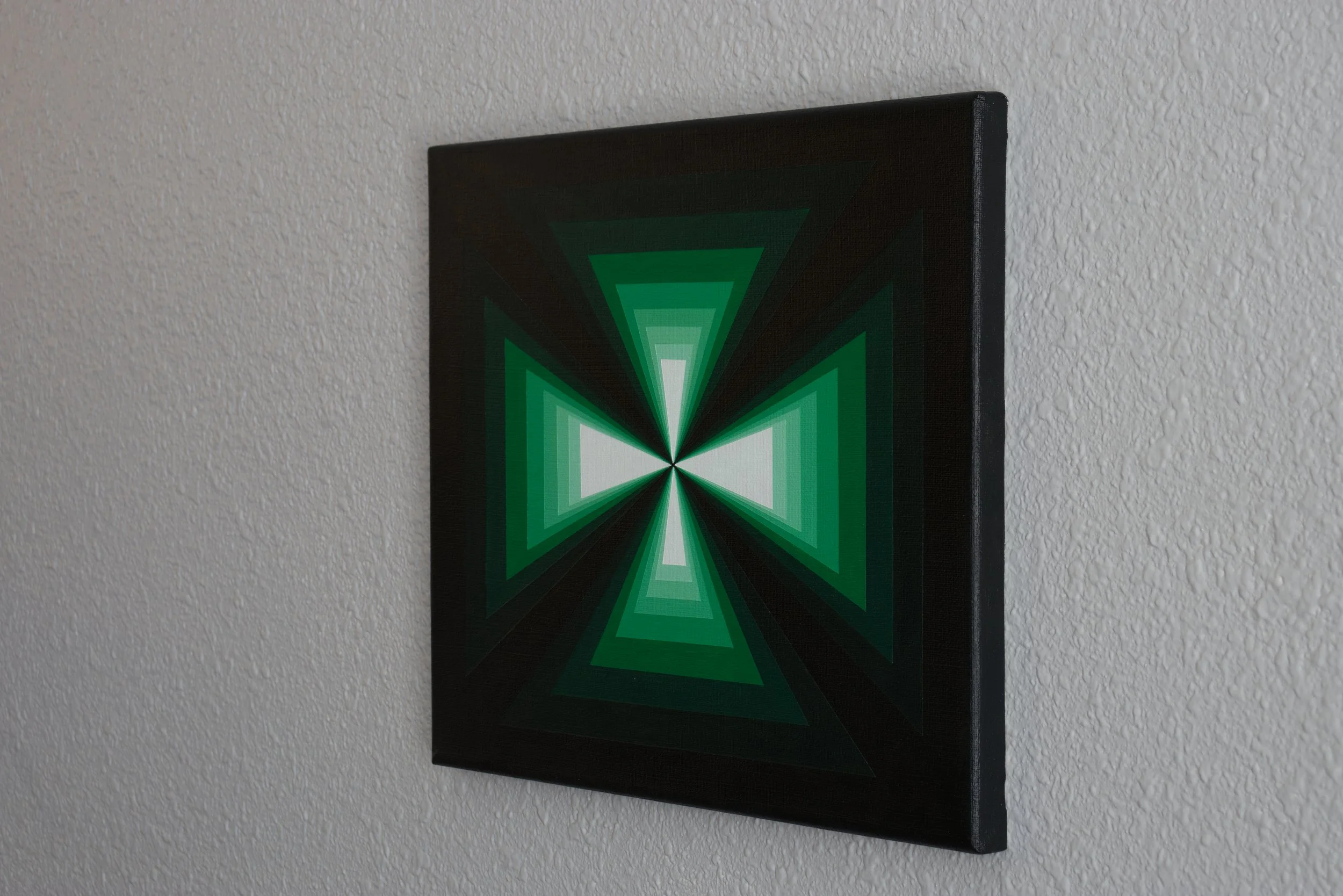 Symmetrical green triangles converging in the middle of the canvas, creating an optical illusion of an infinite geometric tunnel.jpg