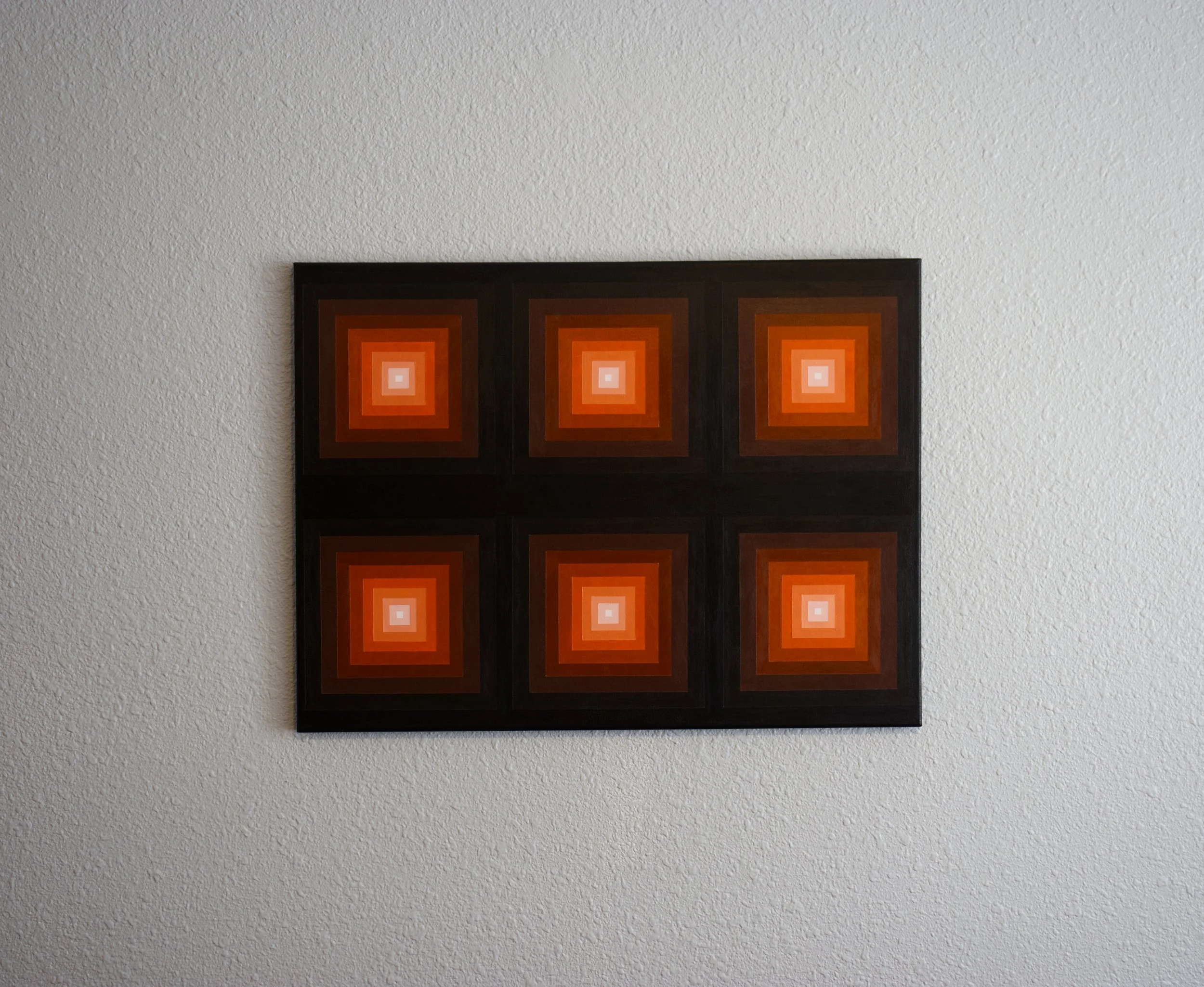 Architectural geometric art featuring a vibrant orange focal point blending into deep red-brown and black outer layers.jpg
