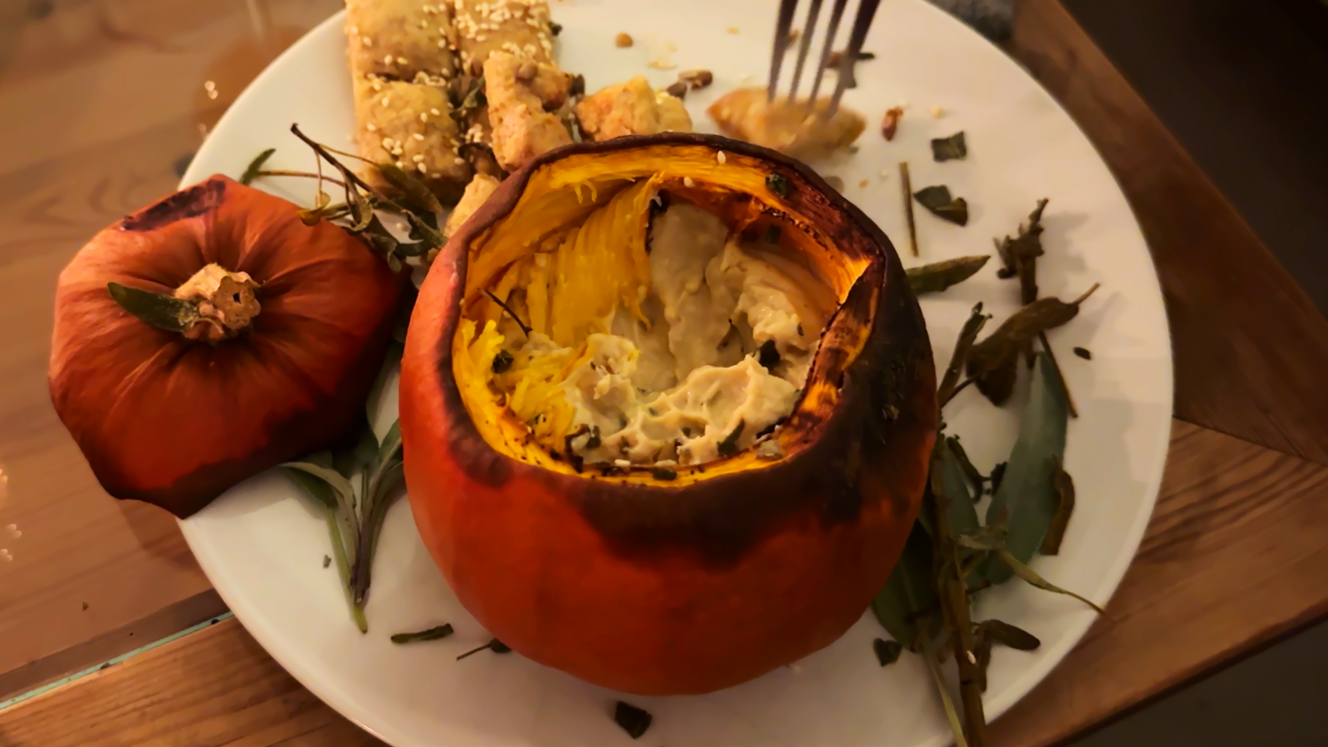 Vegan cheese fondue in a roasted pumpkin