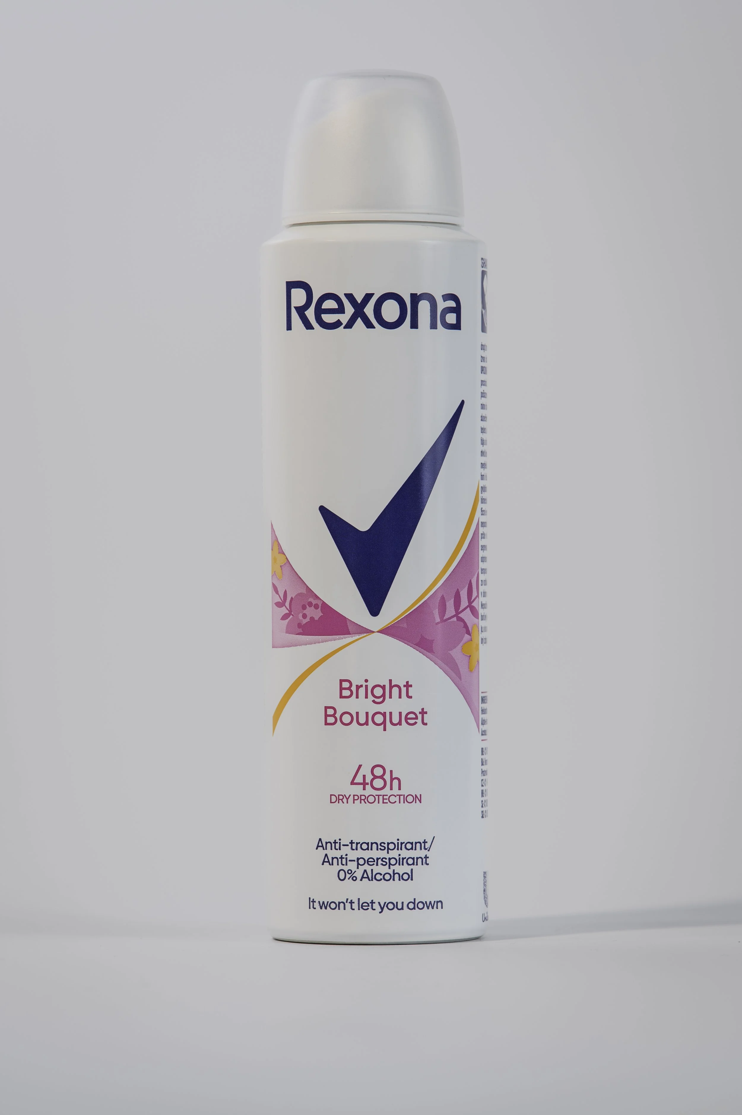 A white aerosol spray can labeled 'Rexona Bright Bouquet' with floral and pink graphics, promoting 48 hours of dry protection, anti-transpirant, anti-perspirant, and 0% alcohol for odor protection.
