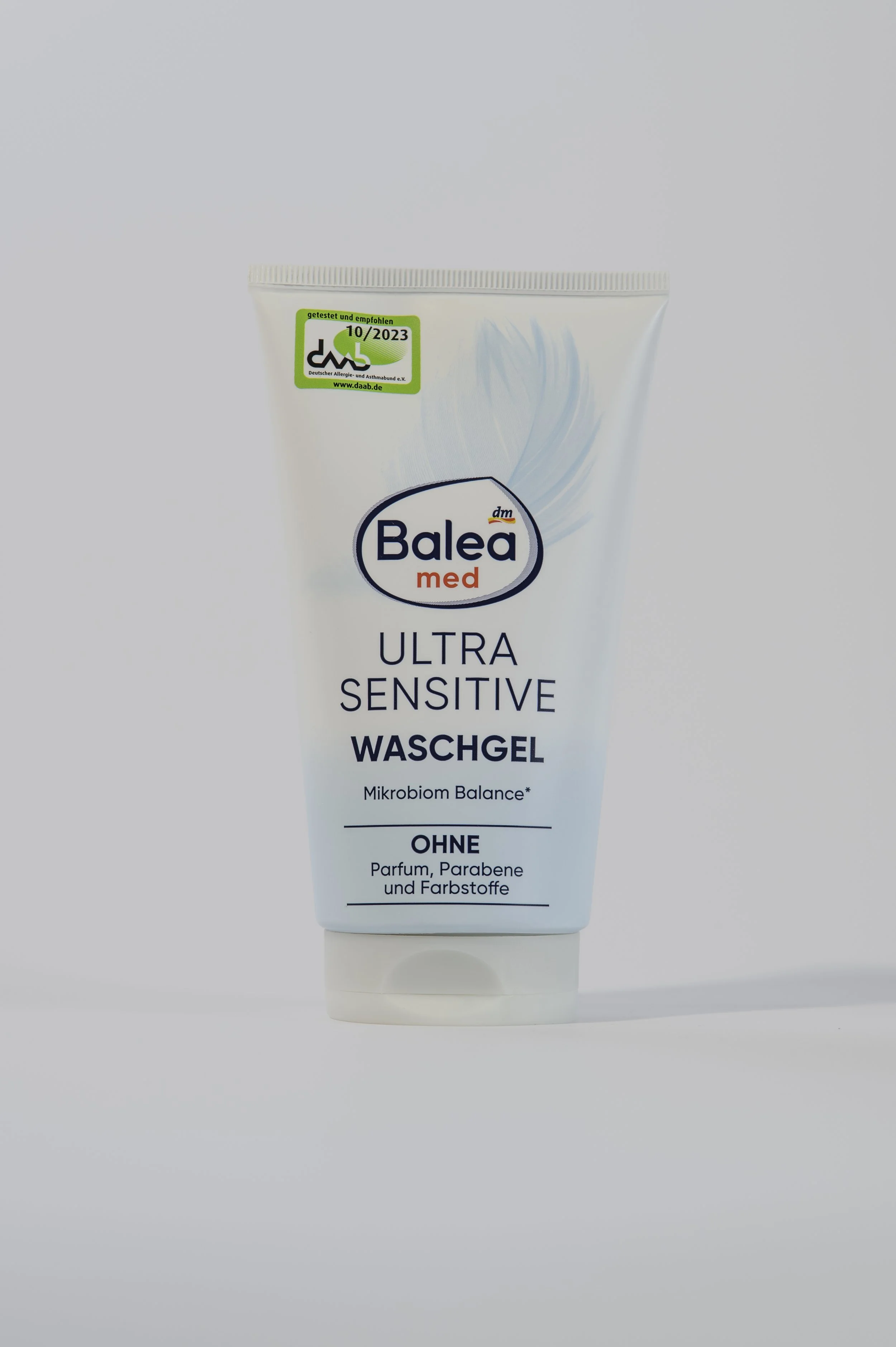 A white tube of Balea Med Ultra Sensitive facial wash with a grey and blue design, placed against a white background. It features a green sticker indicating a test and recommendation from October 2023.