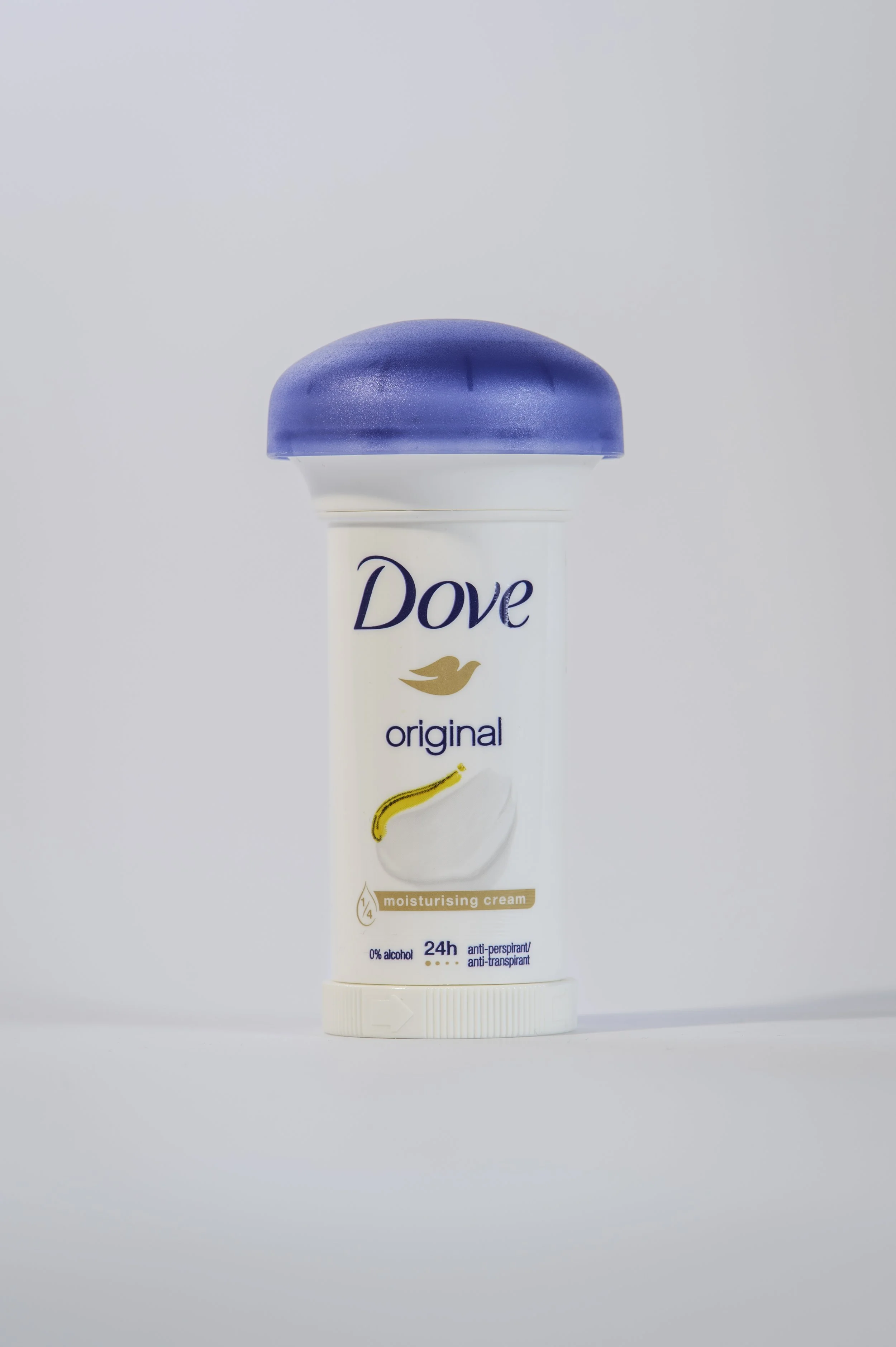 A container of Dove original moisturizing cream with a white body, blue lid, and banana graphic, against a plain light background.
