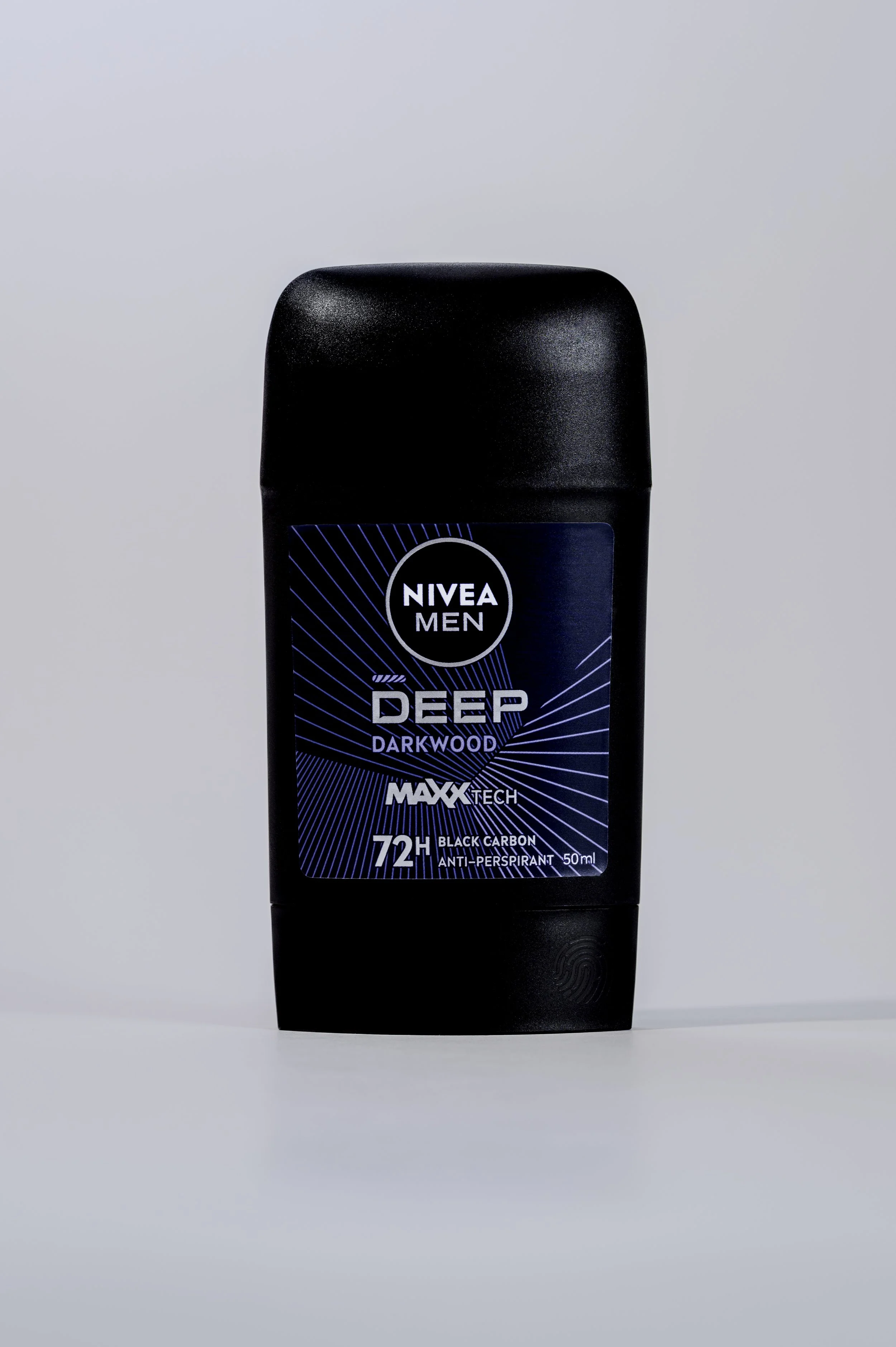 A black container of Nivea Men Deep Darkwood anti-perspirant deodorant with a blue label, featuring details about 72-hour protection, black carbon, and an alcohol-free formula, standing on a flat surface against a plain background.