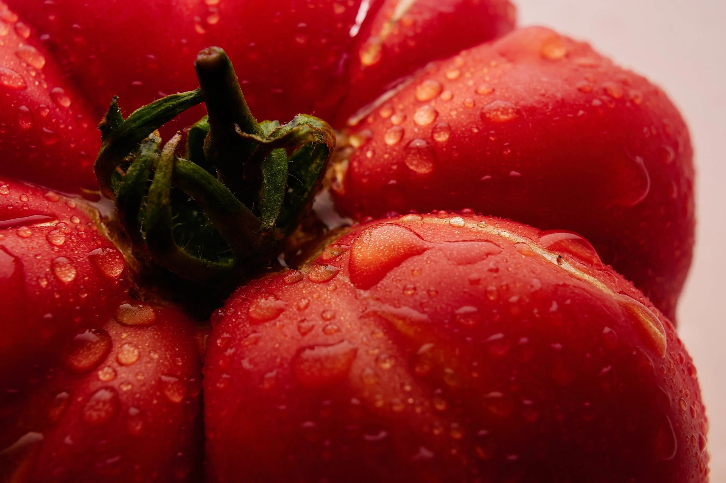 Close-up of red strawberries with water droplets on their surface.