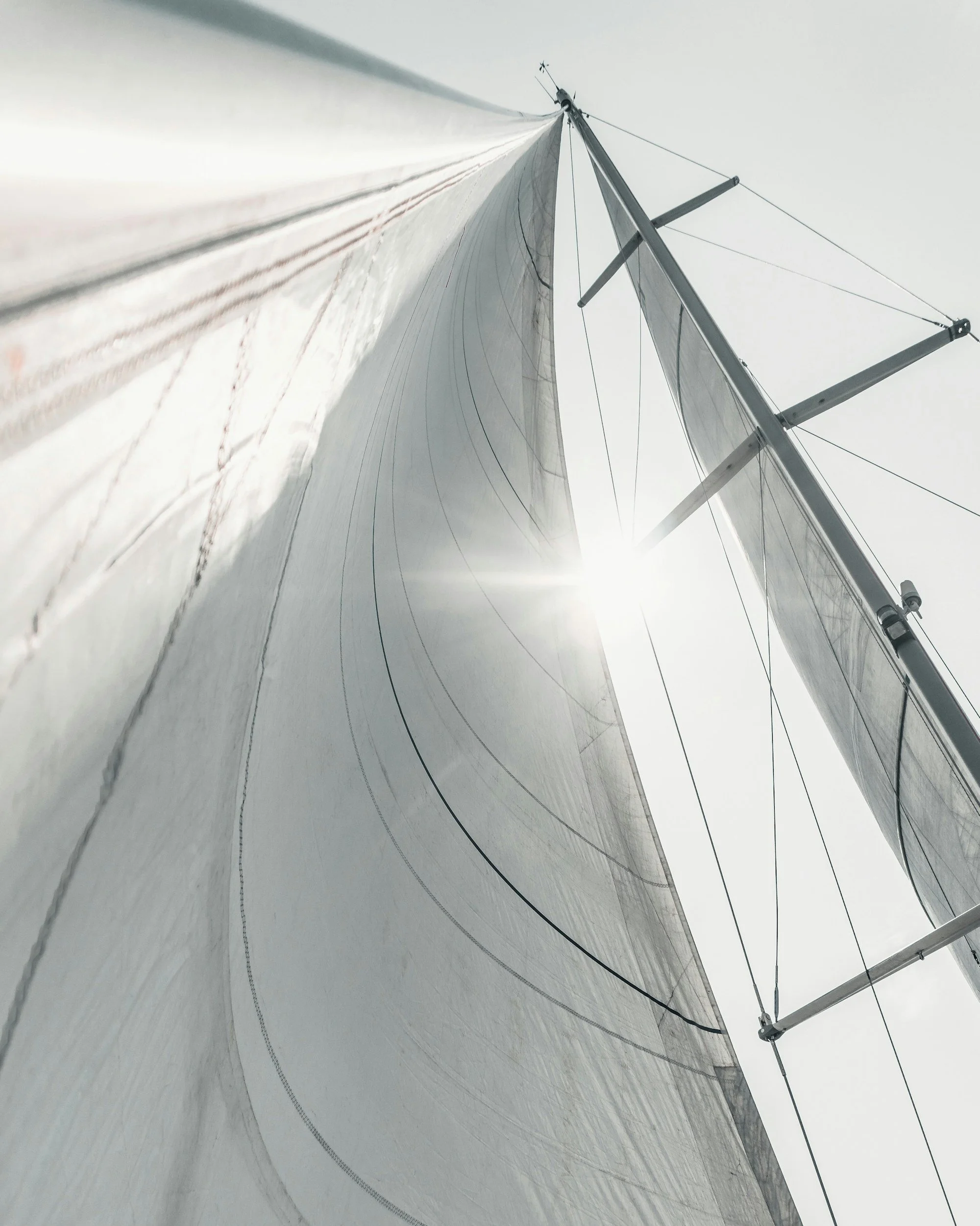 View looking up a yacht mast, forestay, and headsail during rig inspection and measurement.