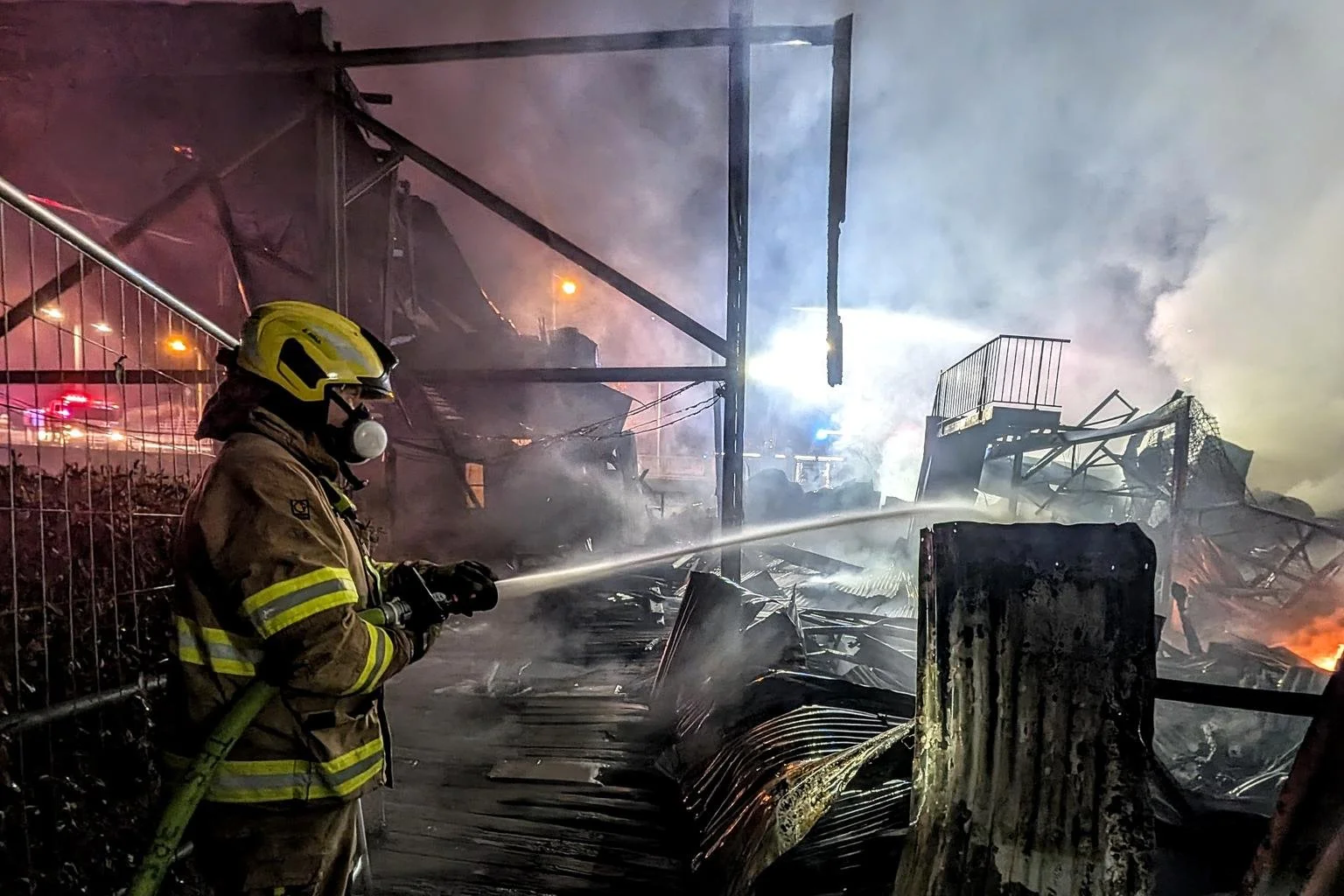 Firefighters responding to the March 2026 fire that destroyed the original Almasts manufacturing facility at Tamar Marine.