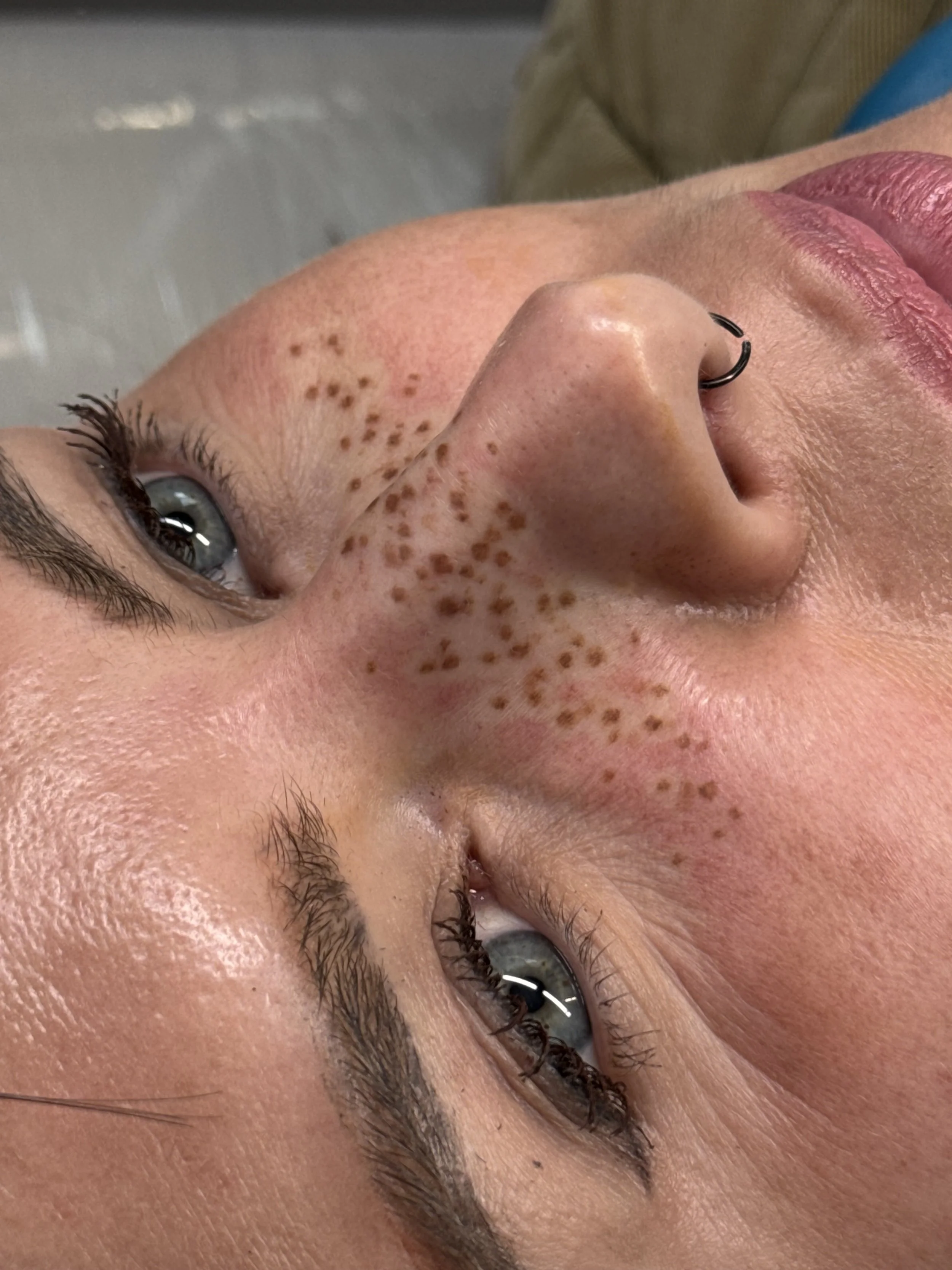 Light coverage faux freckle tattoos