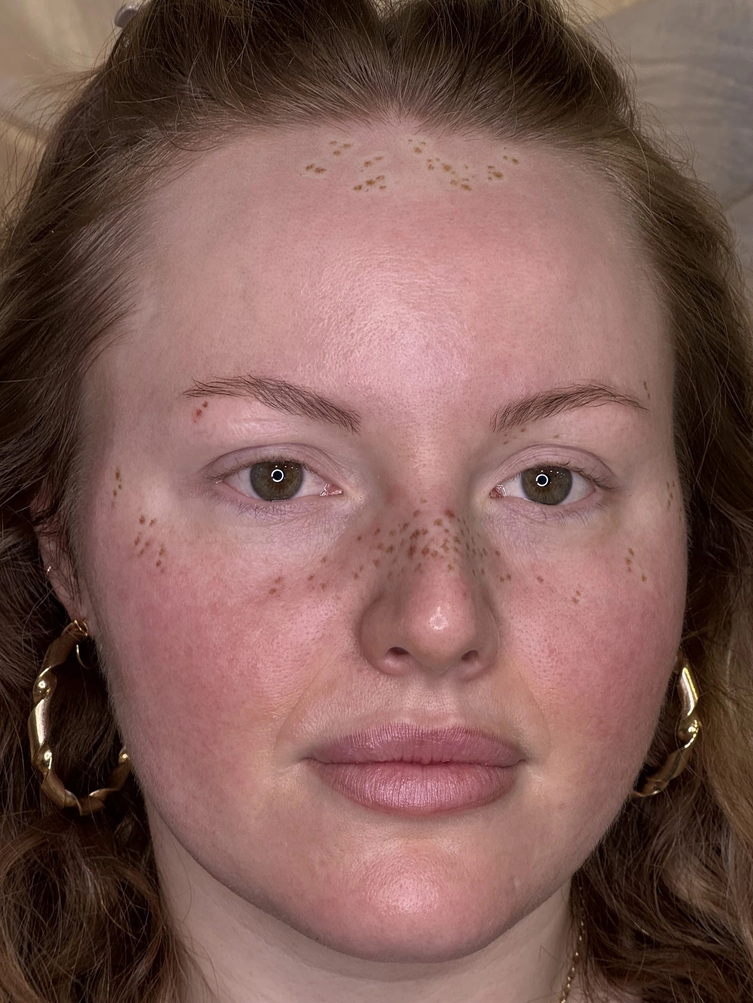 Light coverage faux freckle tattoos