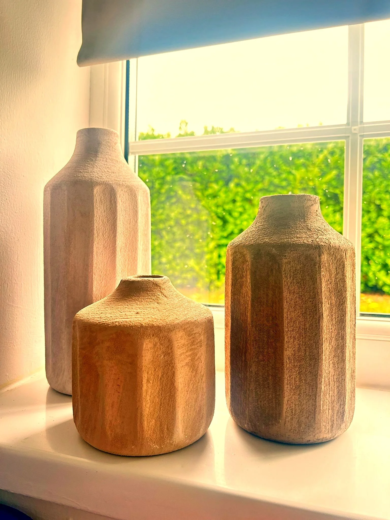 Three decorative pots in the window of the dermal filler treatment room, North Glow Aesthetics based in Norden, Rochdale.
