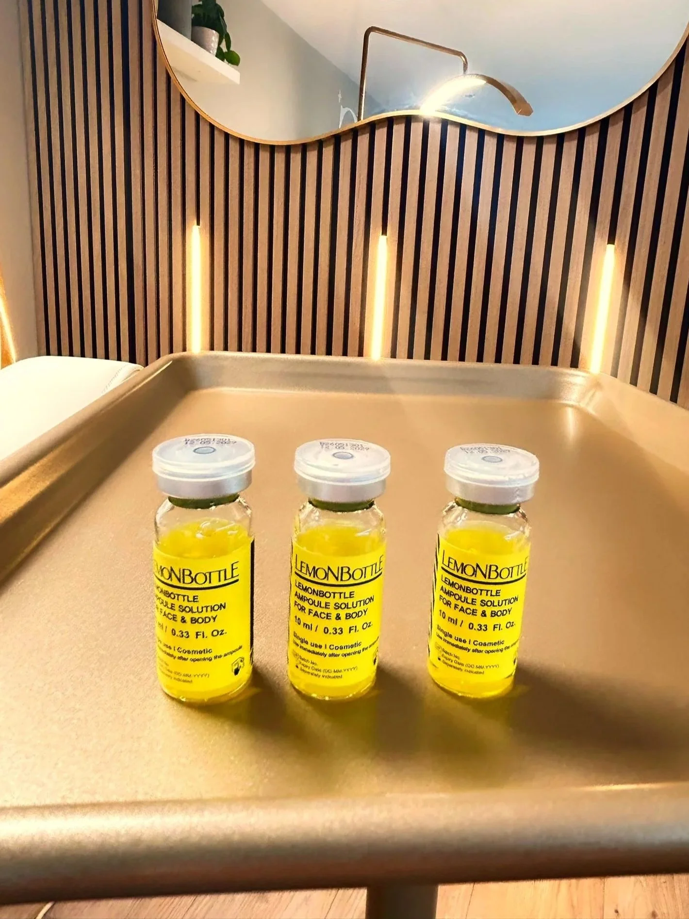 Three LemonBottle fat dissolving ampoules on a gold treatment tray at North Glow Aesthetics, Norden, Rochdale.