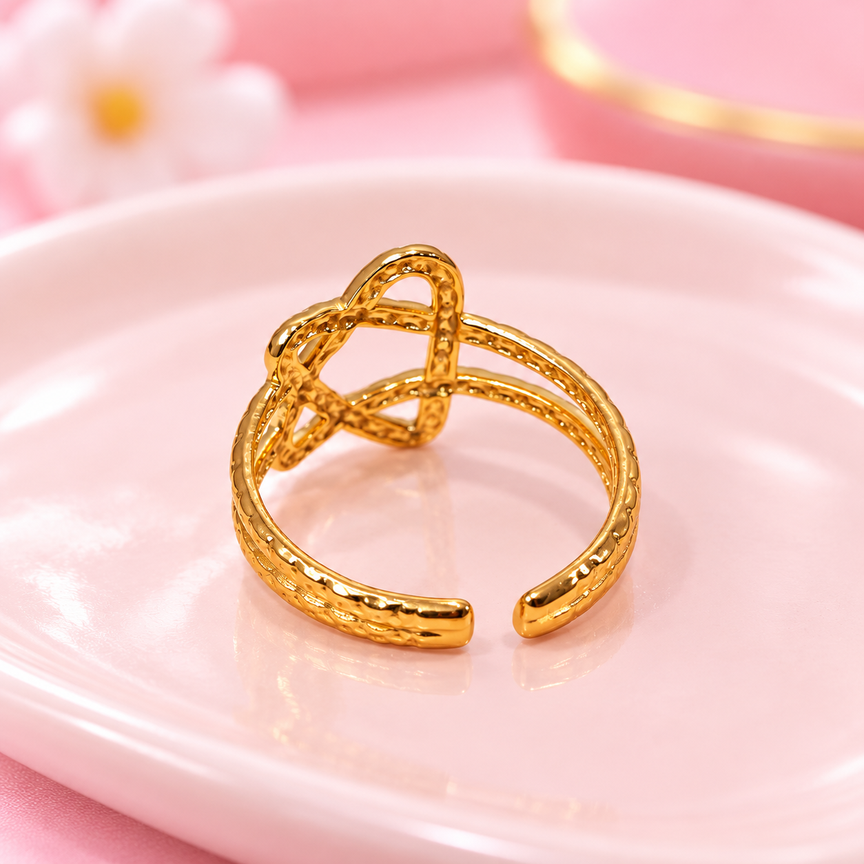 Gold Knot Ring on a Dreamy Pink Dish.png