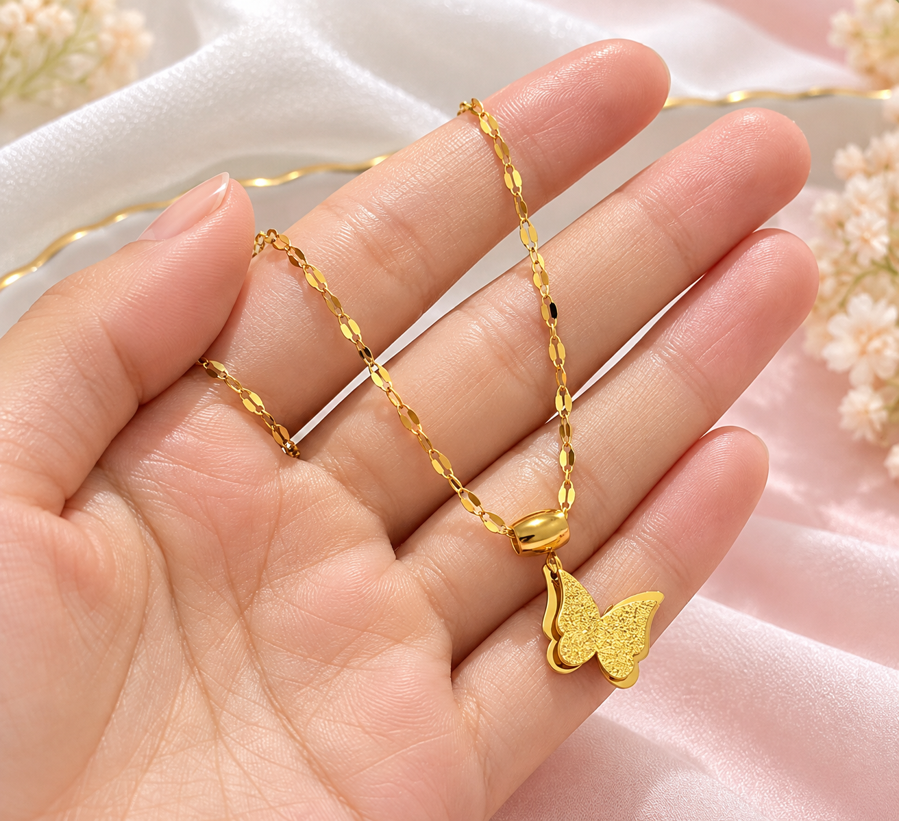Gold Butterfly Necklace in Hand.png