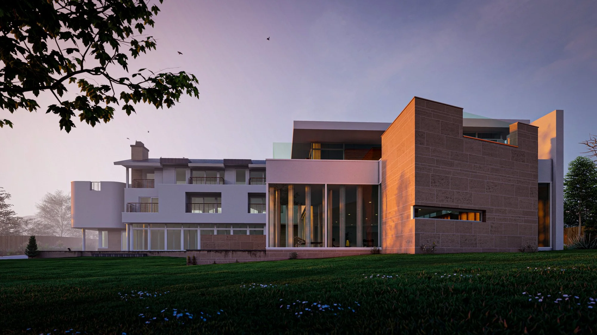 Modern multi-story house with large windows and a combination of white and brown exterior walls, surrounded by green lawn and trees at dusk.