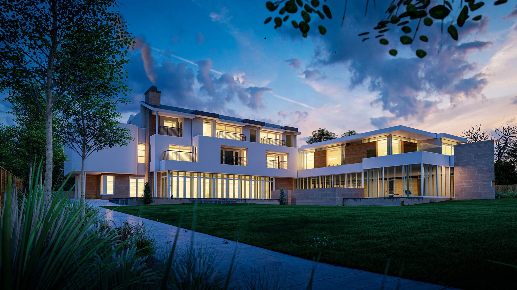 Modern multi-story house with large windows, illuminated interior lights, surrounded by a landscaped yard with grass, trees, and a pathway during dusk with a cloudy sky.