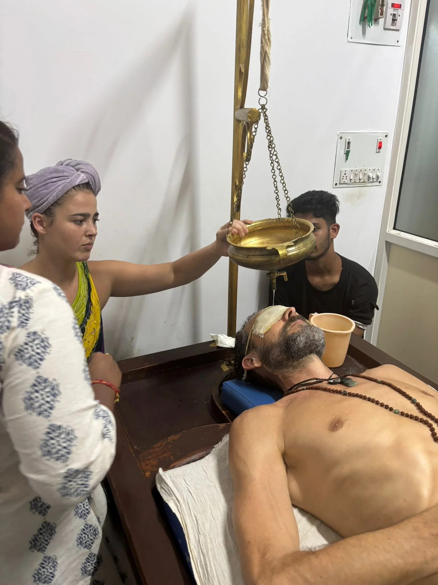A woman performing a traditional ayurvedic treatment