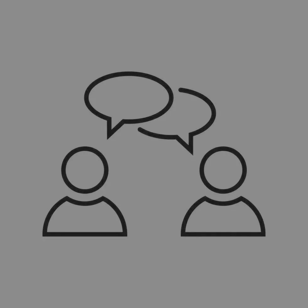 Icon of two people engaged in conversation with speech bubbles.