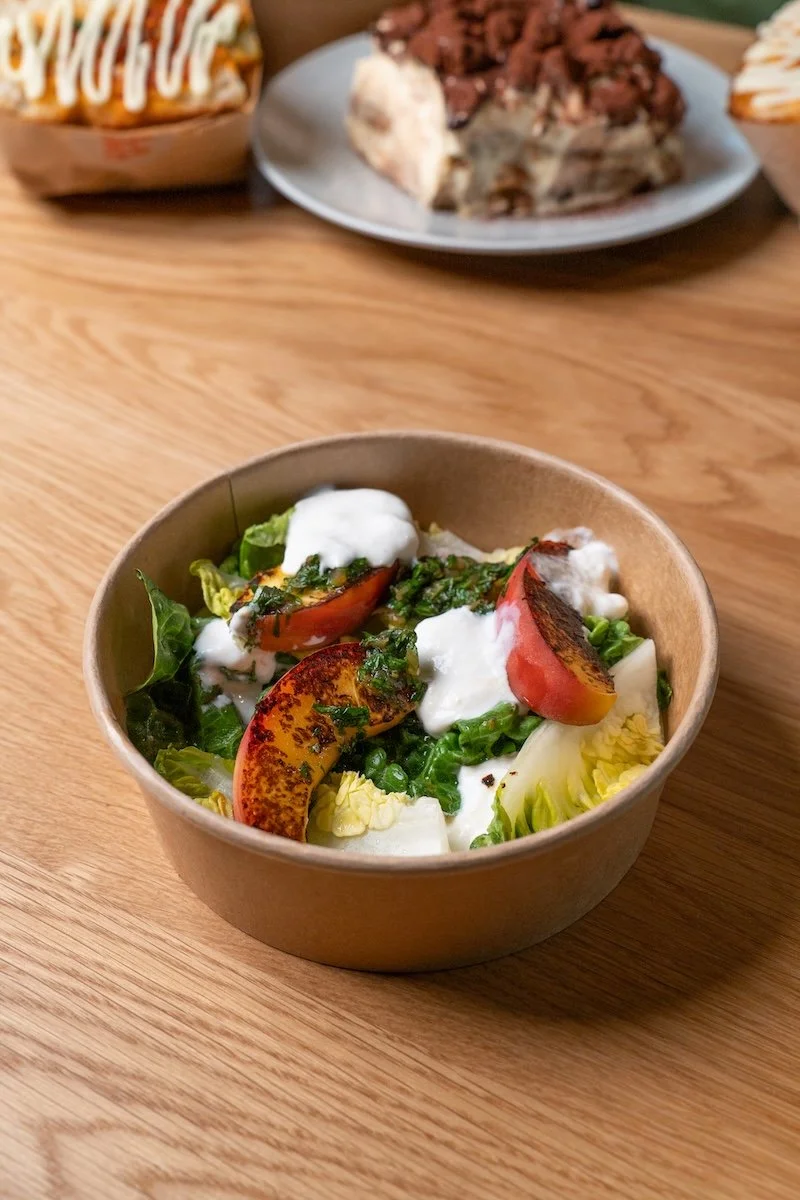 Fresh stracciatella peach salad with baby gem, roasted peach and chimichurri from Alla Mano in Zurich