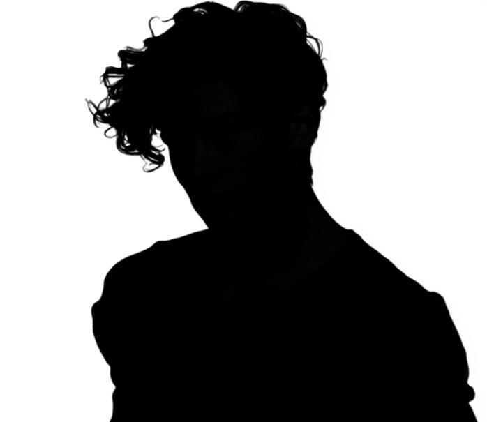 Silhouette of a person with curly hair against a white background.