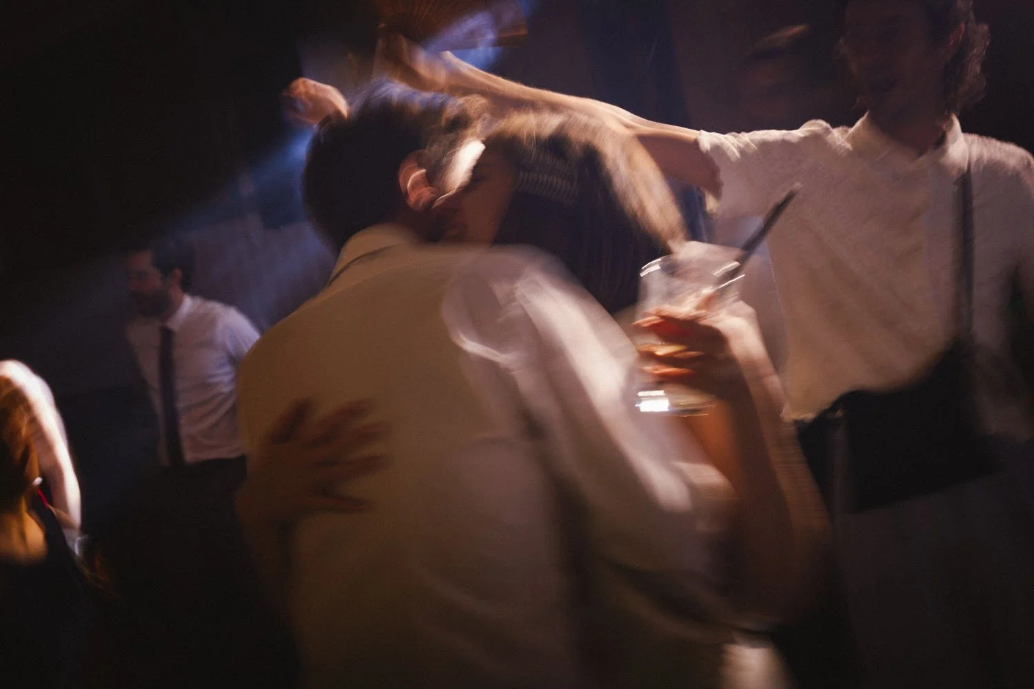 Cinematic photo of a couple dancing at a wedding party.