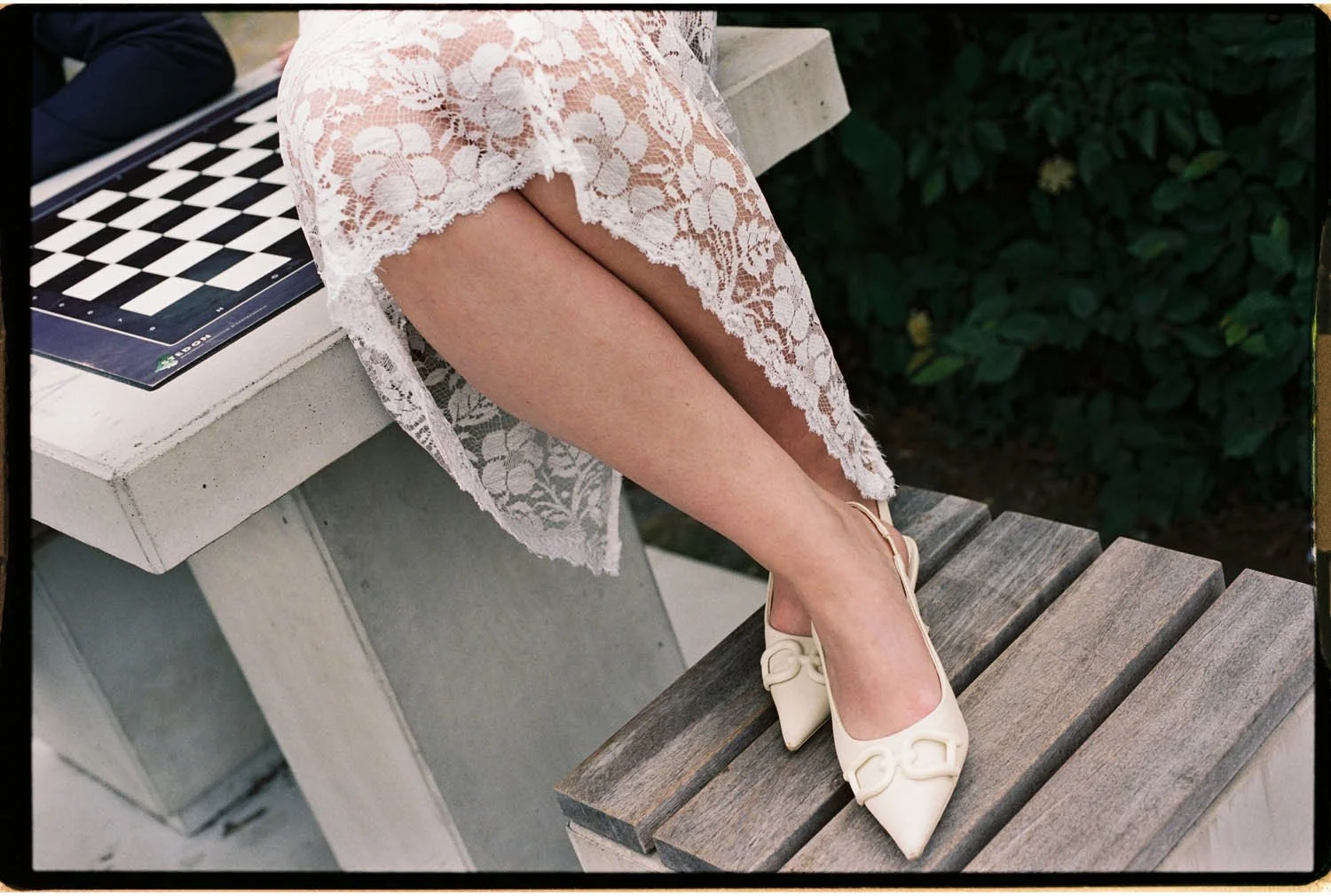 editorial style detail image of bride legs crossed with hills
