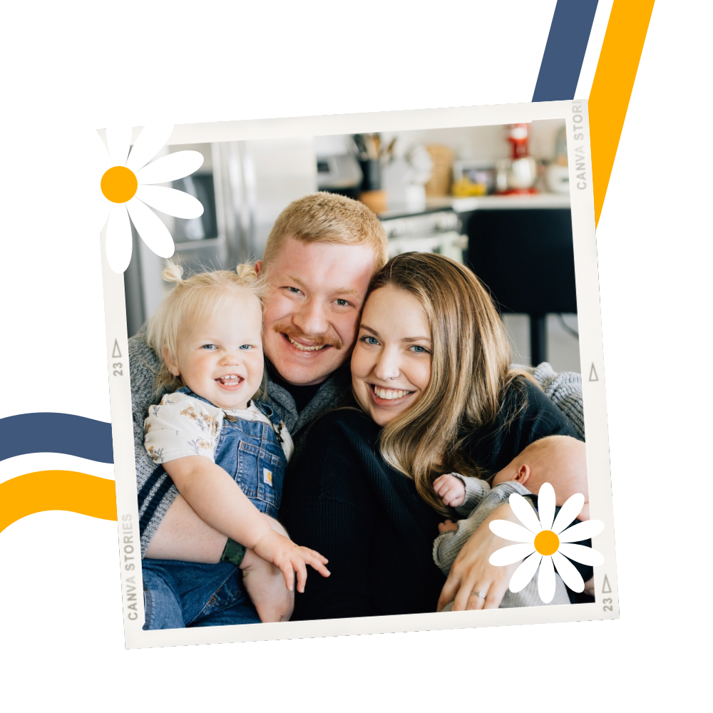Smiling family squished into a frame with daisies