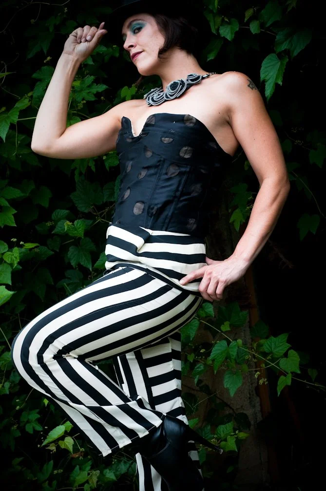 Silk stripe pants with black silk circle bustier and zipper necklace