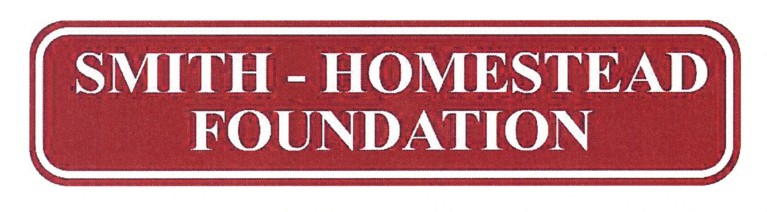 Red street sign with white border and text reading 'SMITH-HOMESTEAD FOUNDATION'.