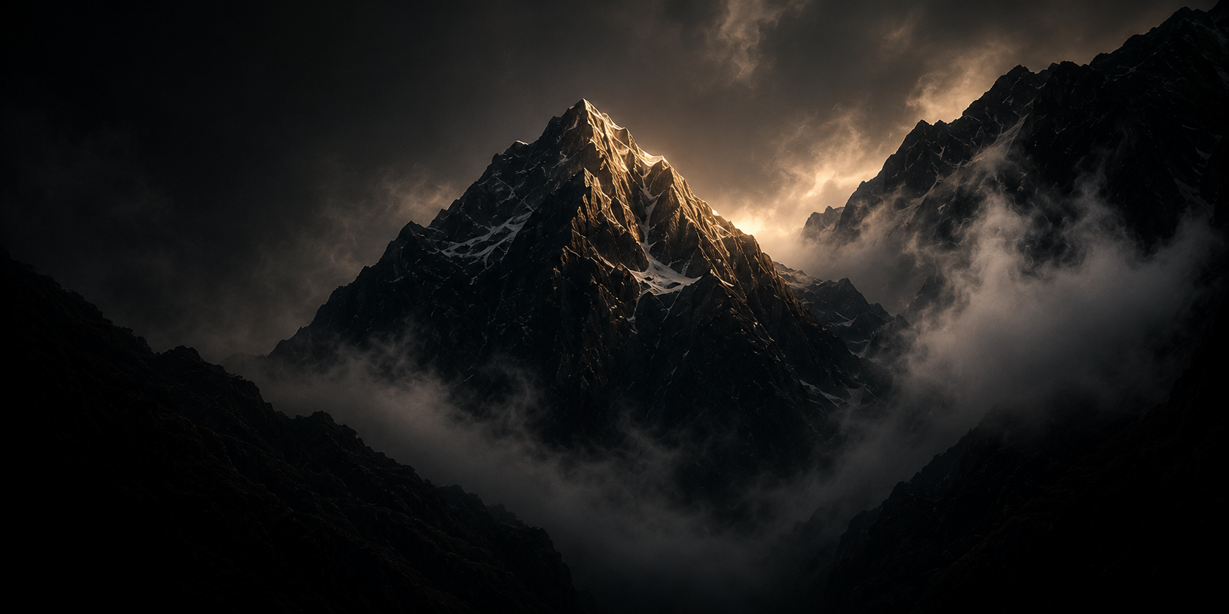 A dark mountain landscape with snow-capped peaks, partially covered by clouds and illuminated by a subtle glow.