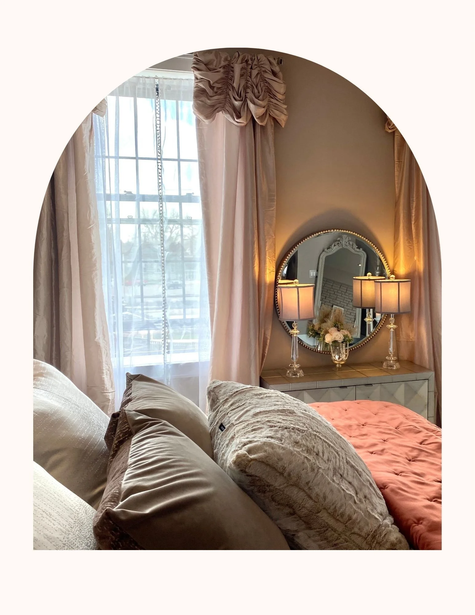 A romantic Airbnb in Fairbury, Illinois with cozy bedroom corner with a window, curtains, a mirror, lamps, and beds with plush pillows and blankets. Perfect for a romantic couples getaway.