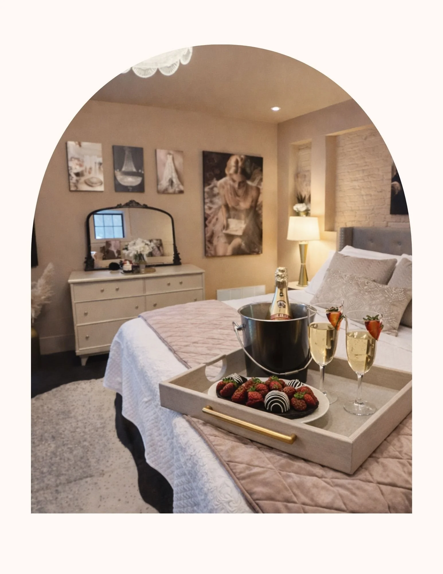 Unique vintage Hollywood glam style Airbnb. A romantic bedroom decorated with wall art, a lamp, and a mirror. Perfect for romantic couples getaway in central Illinois.