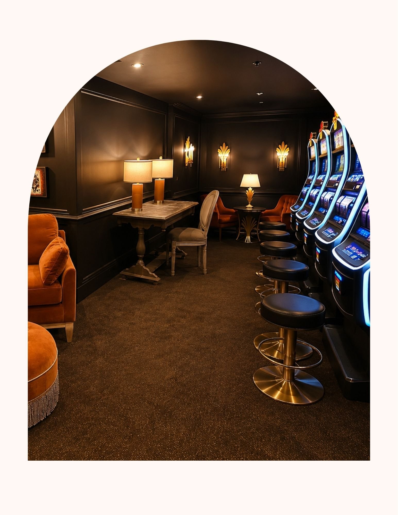 An elegant gaming room with a luxury casino feel with black walls, featuring a sofa, a marble table with lamps, and a row of slot machines with blue lighting on the right side. Feels somewhat private.