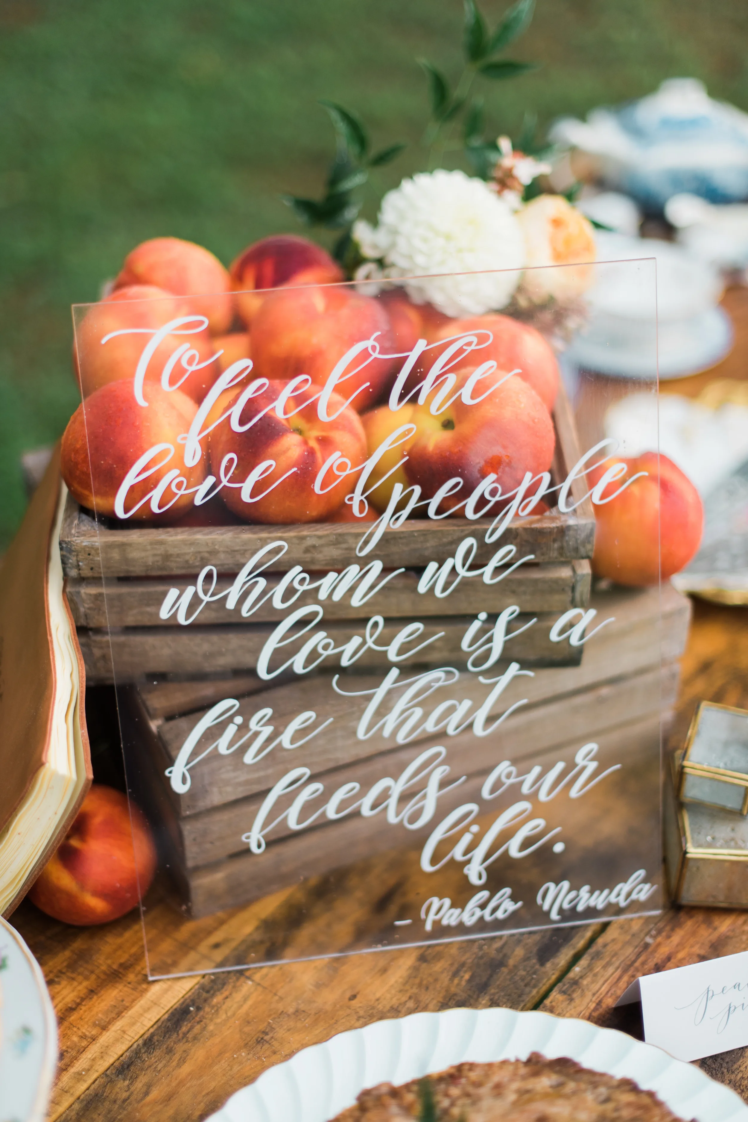 Custom clear acrylic wedding sign quote for a food table at a southern outdoor wedding.
