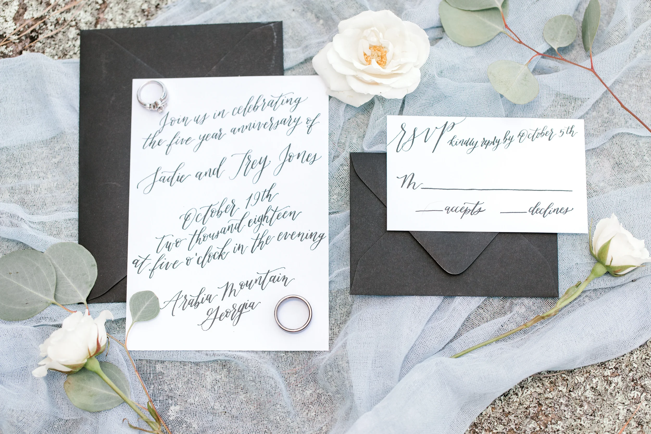 Formal five-year anniversary invitation card featuring elegant black script calligraphy and a diamond ring.