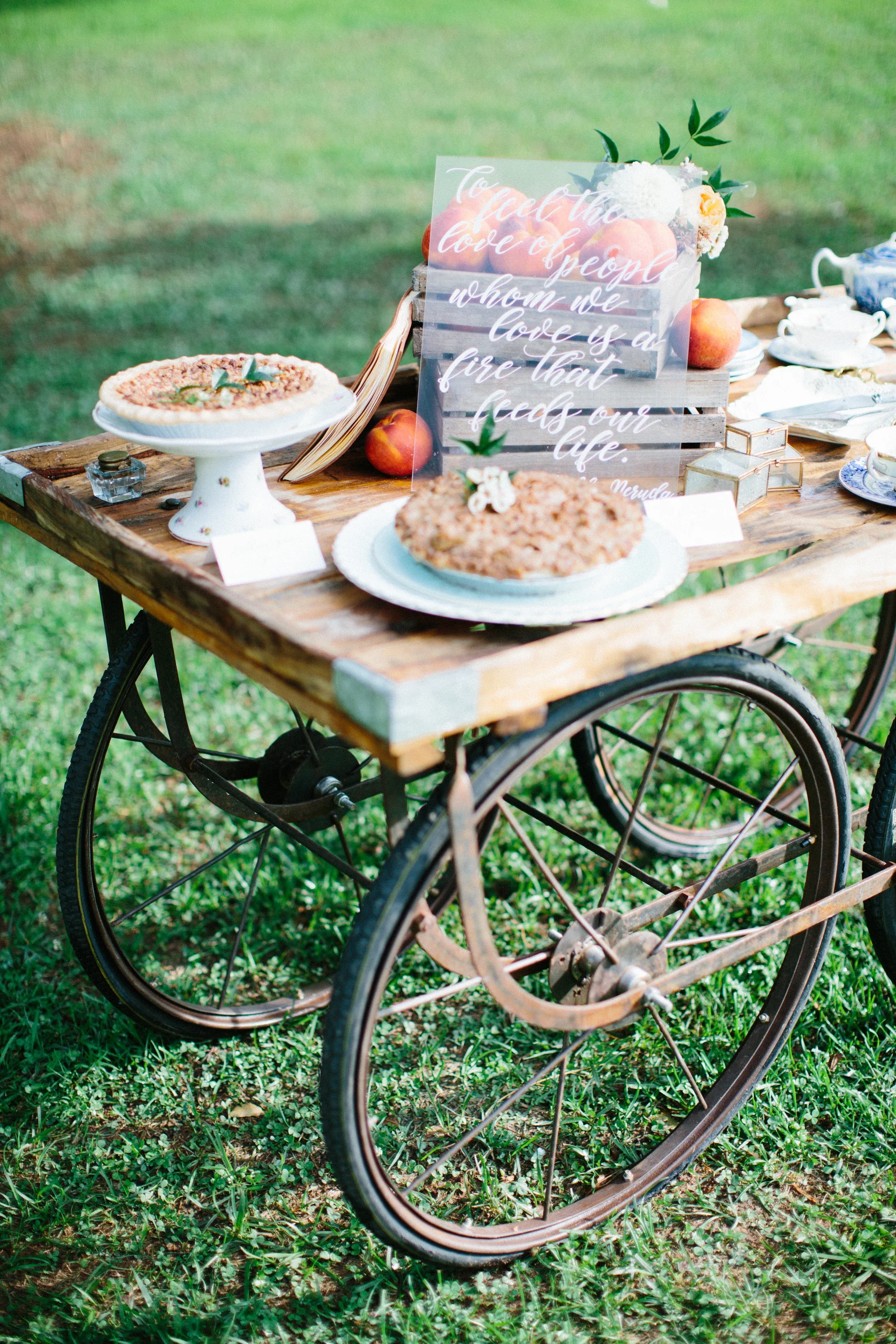Custom clear acrylic wedding sign quote on a dessert table at an outdoor southern wedding.