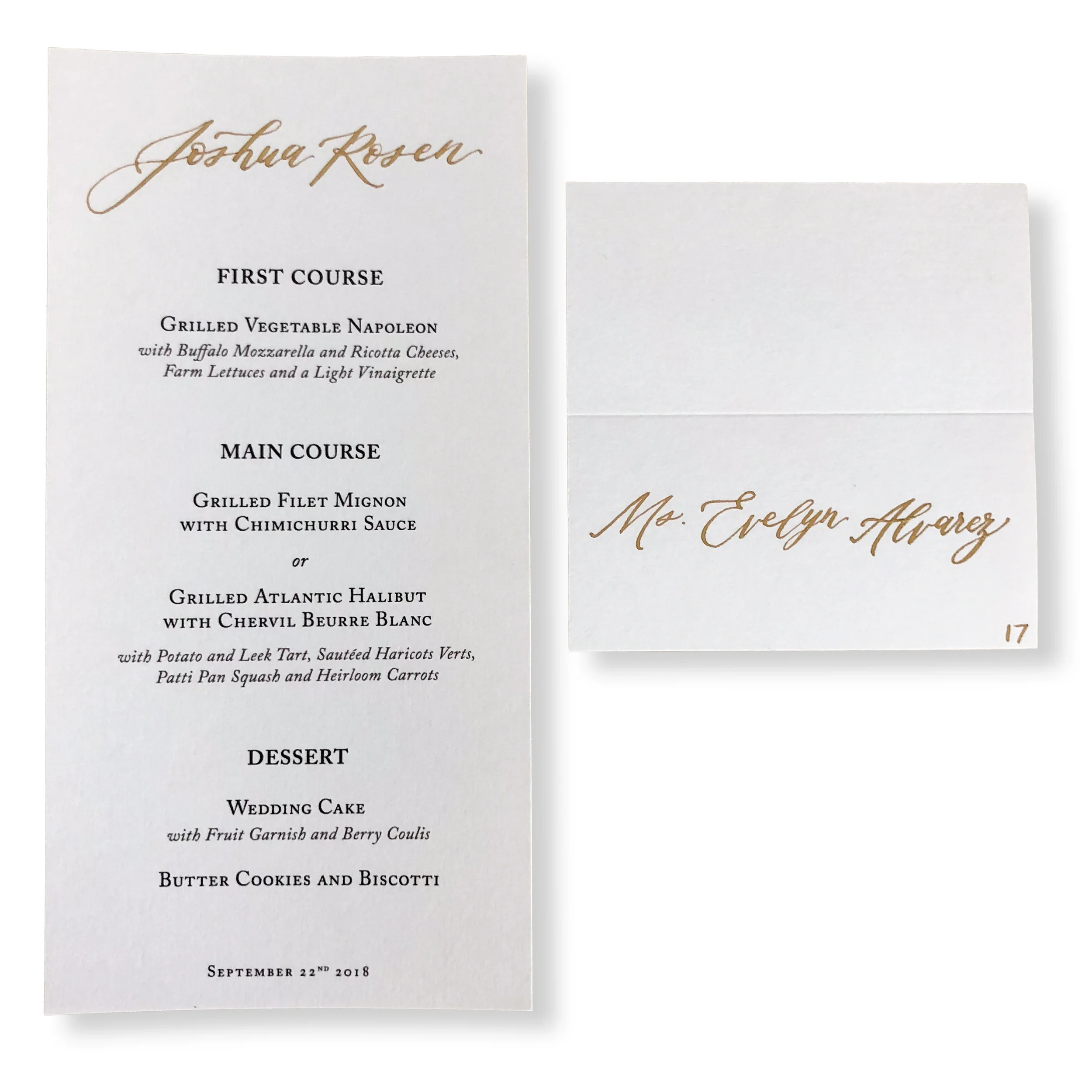 Gold ink calligraphy escort card and custom place card menu on white paper.