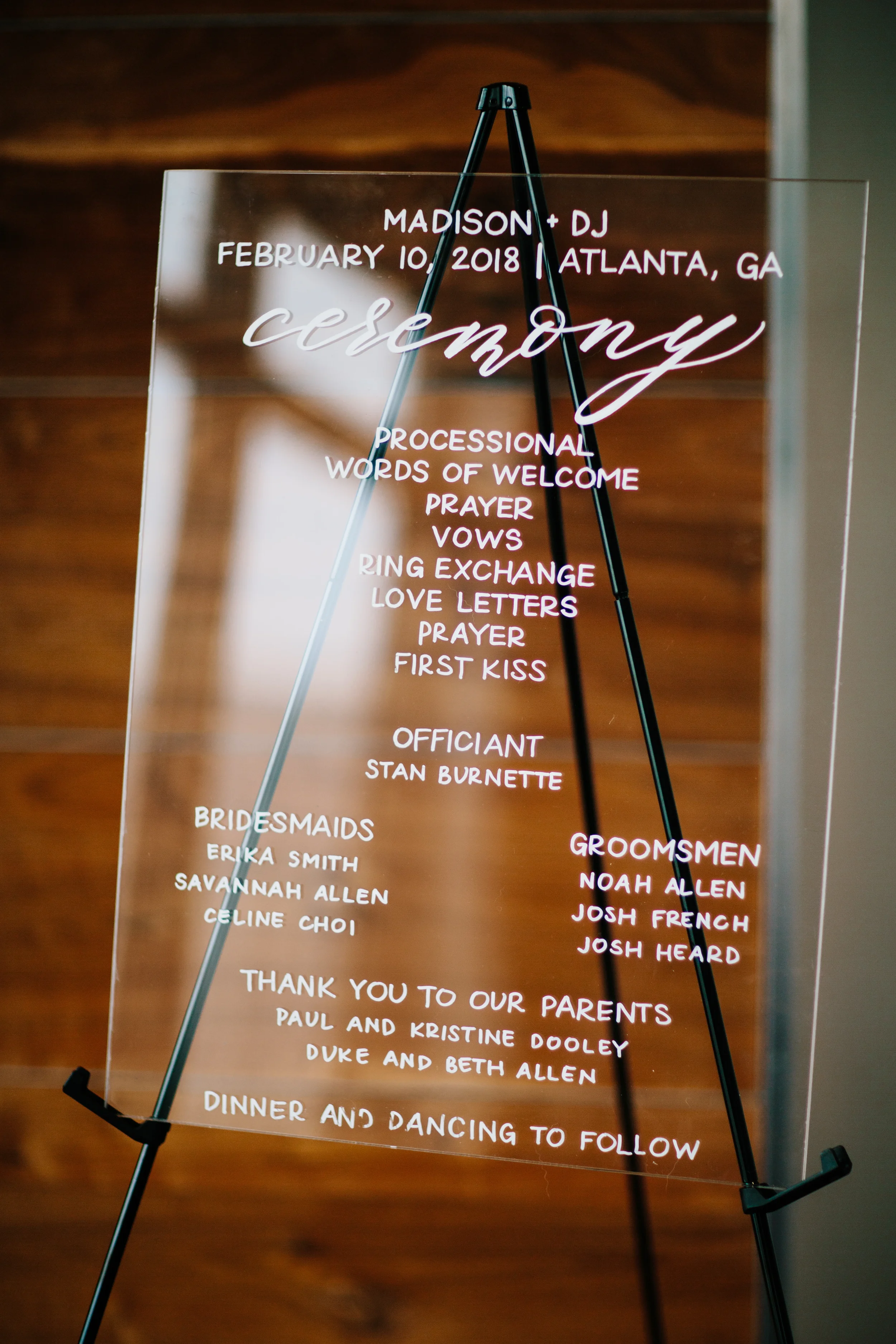 Guide your guests flawlessly through a high-end city celebration using a clear acrylic wedding timeline sign. By blending structured sans-serif block lettering with expressive hand-written calligraphy accents, this signage piece stays perfectly legib