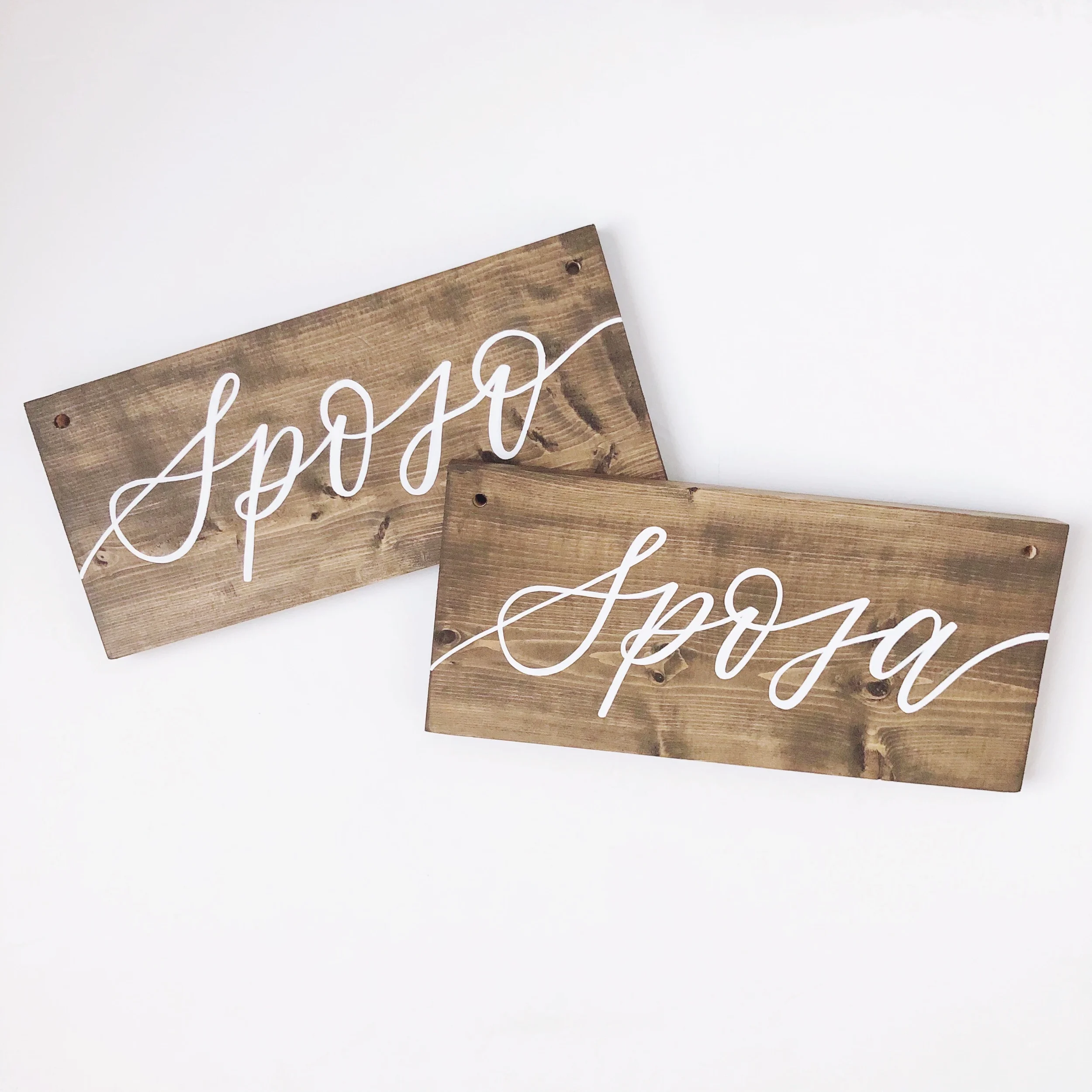 Italian bride and groom wooden chair signs with flowing white cursive calligraphy script.