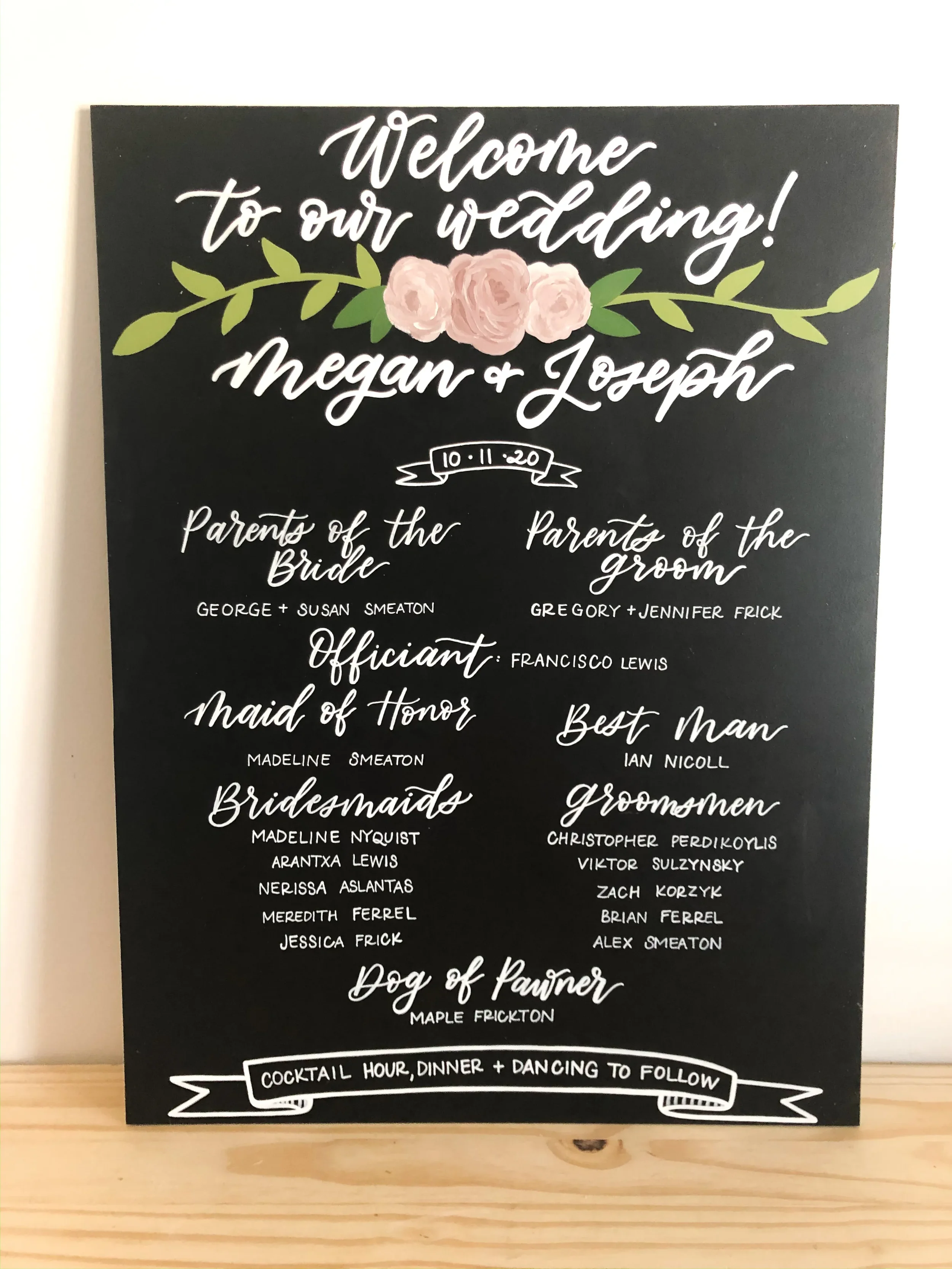 Custom hand-lettered chalkboard sign displaying parents of the bride, groom, and wedding party members.
