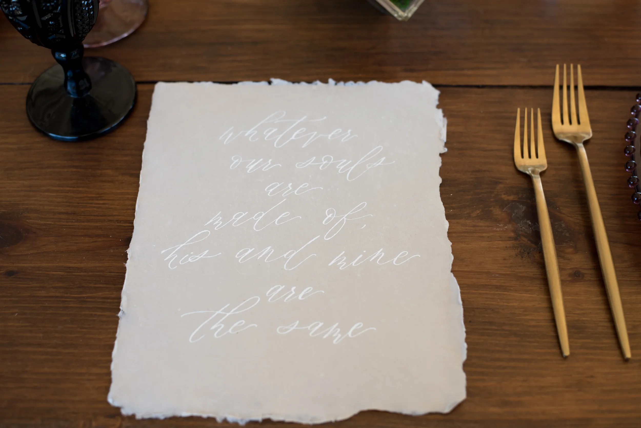 Express your deepest sentiments with fine-art quote calligraphy on handmade deckled-edge paper. Written in ethereal white ink featuring the iconic Wuthering Heights quote, "Whatever our souls are made of, his and mine are the same," this piece makes 