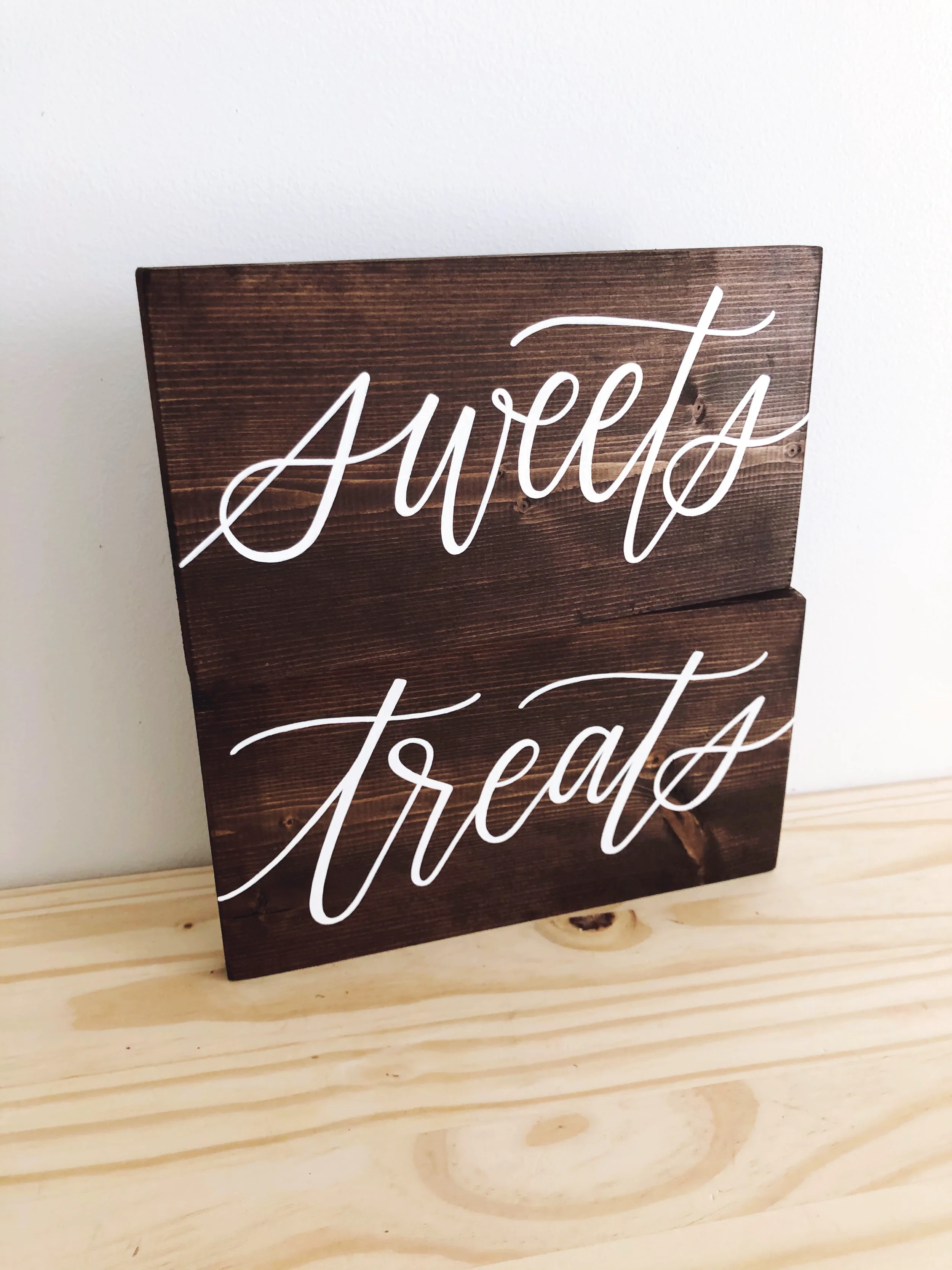 Dark stained wood "sweets" and "treats" signs for wedding dessert table.