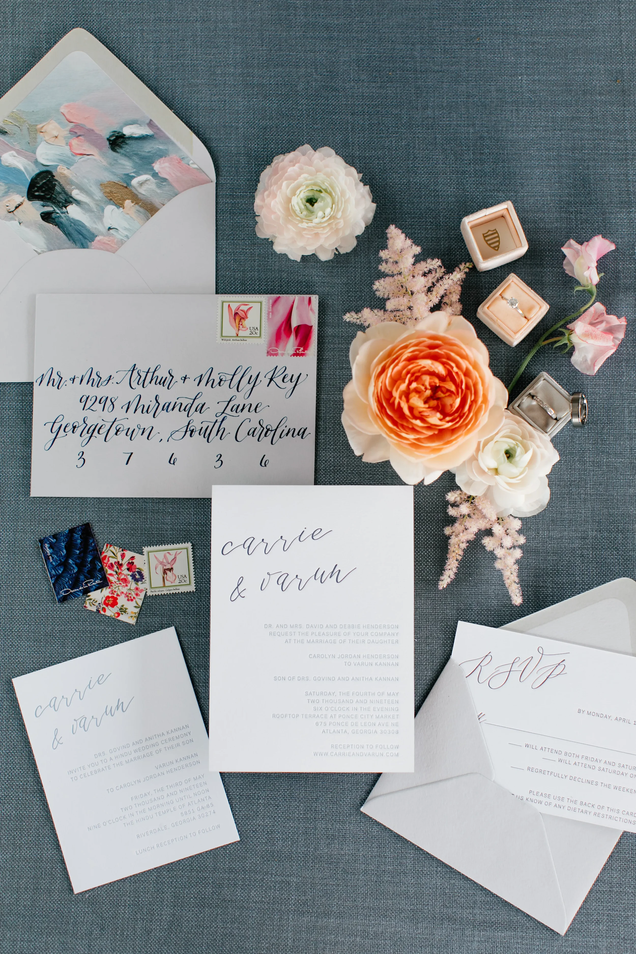Elegant white wedding invitation suite with an abstract painted envelope liner and fresh spring florals.