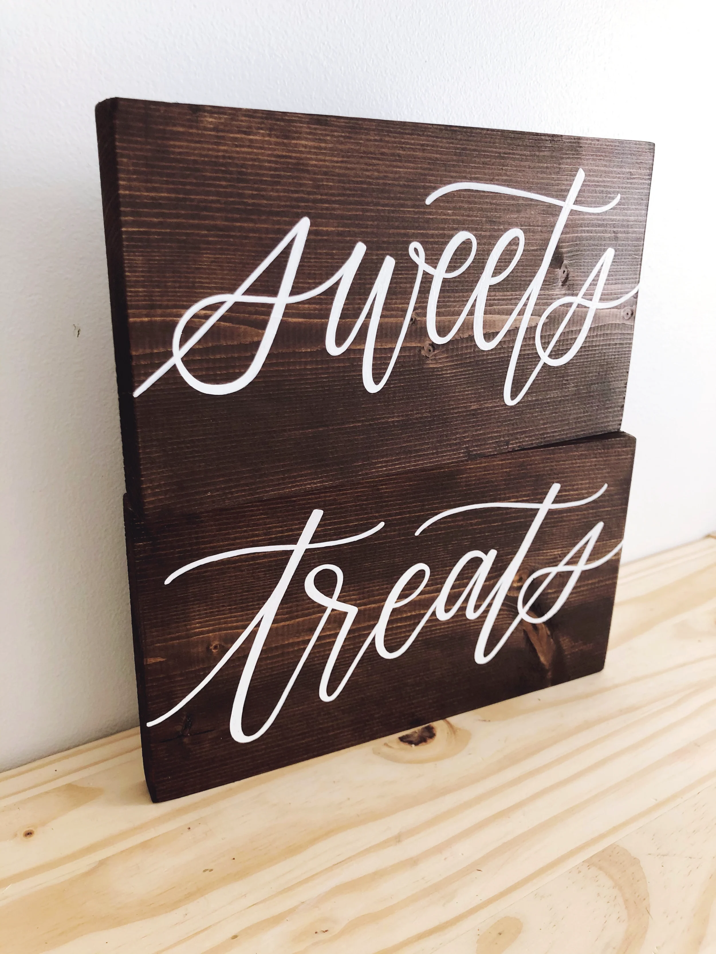 Dark stained wood "sweets" and "treats" signs for wedding dessert table.