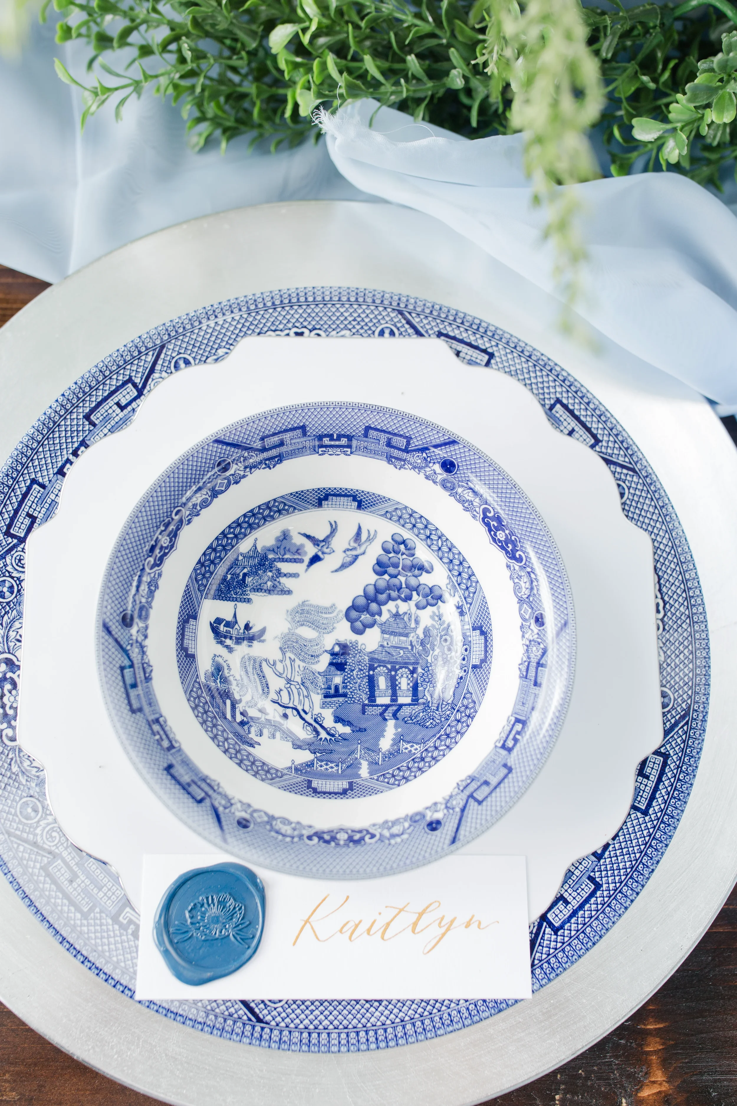 Classic southern blue willow tableware setting featuring a hand-lettered gold calligraphy place card.