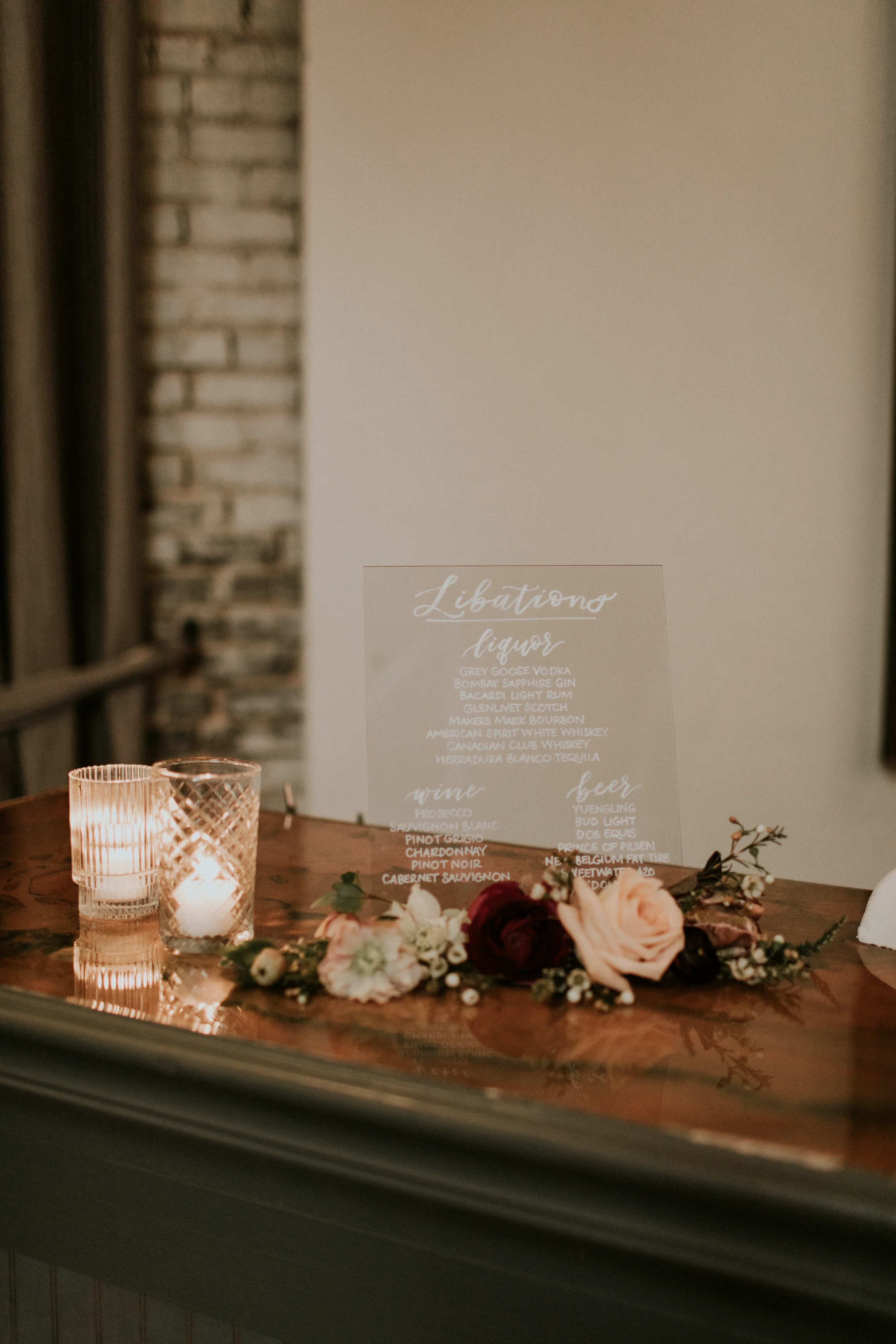 Dark and moody wedding bar sign with white hand-lettering calligraphy for an industrial Georgia wedding.