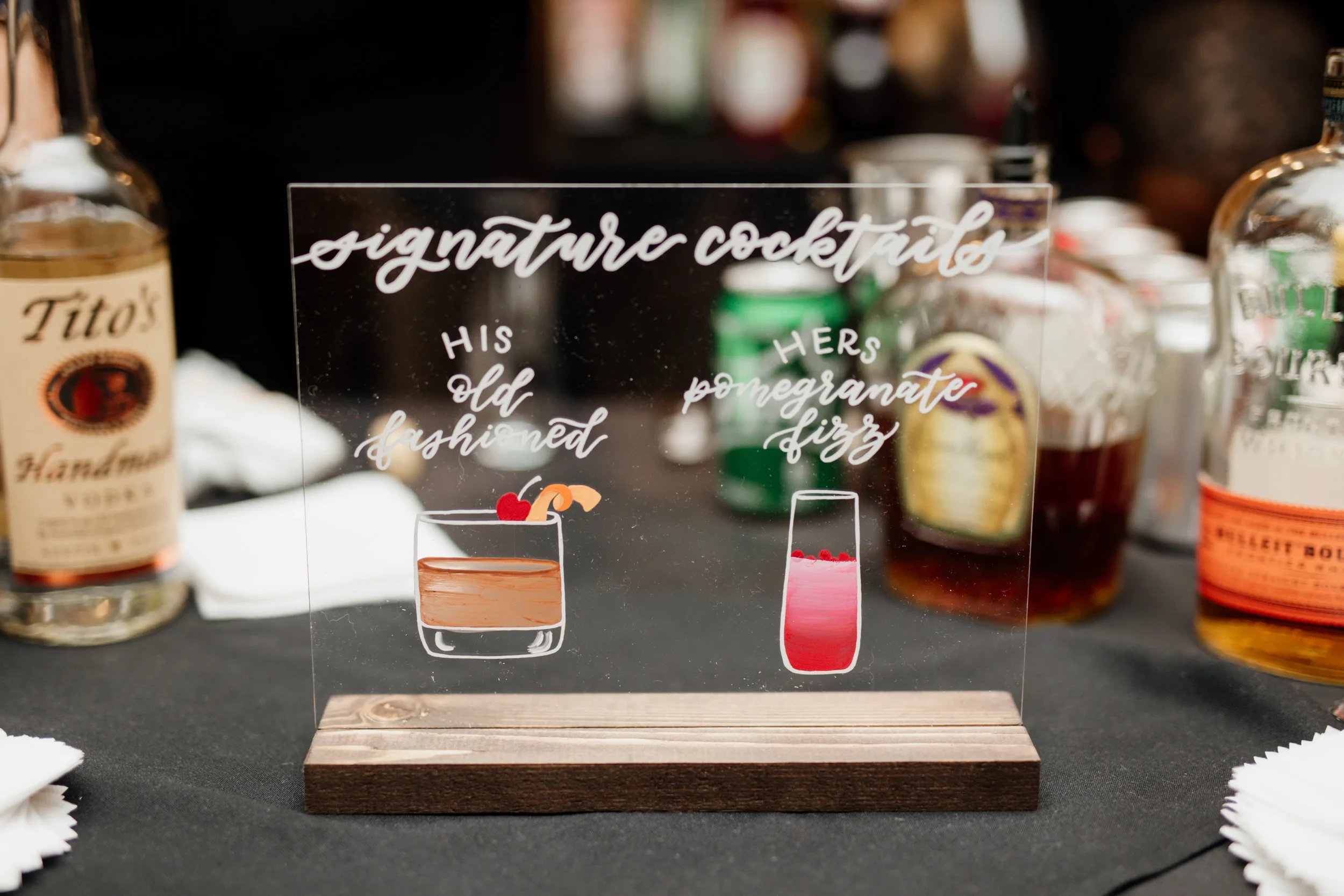 Modern wedding bar menu sign with custom drink graphics and white ink calligraphy. 