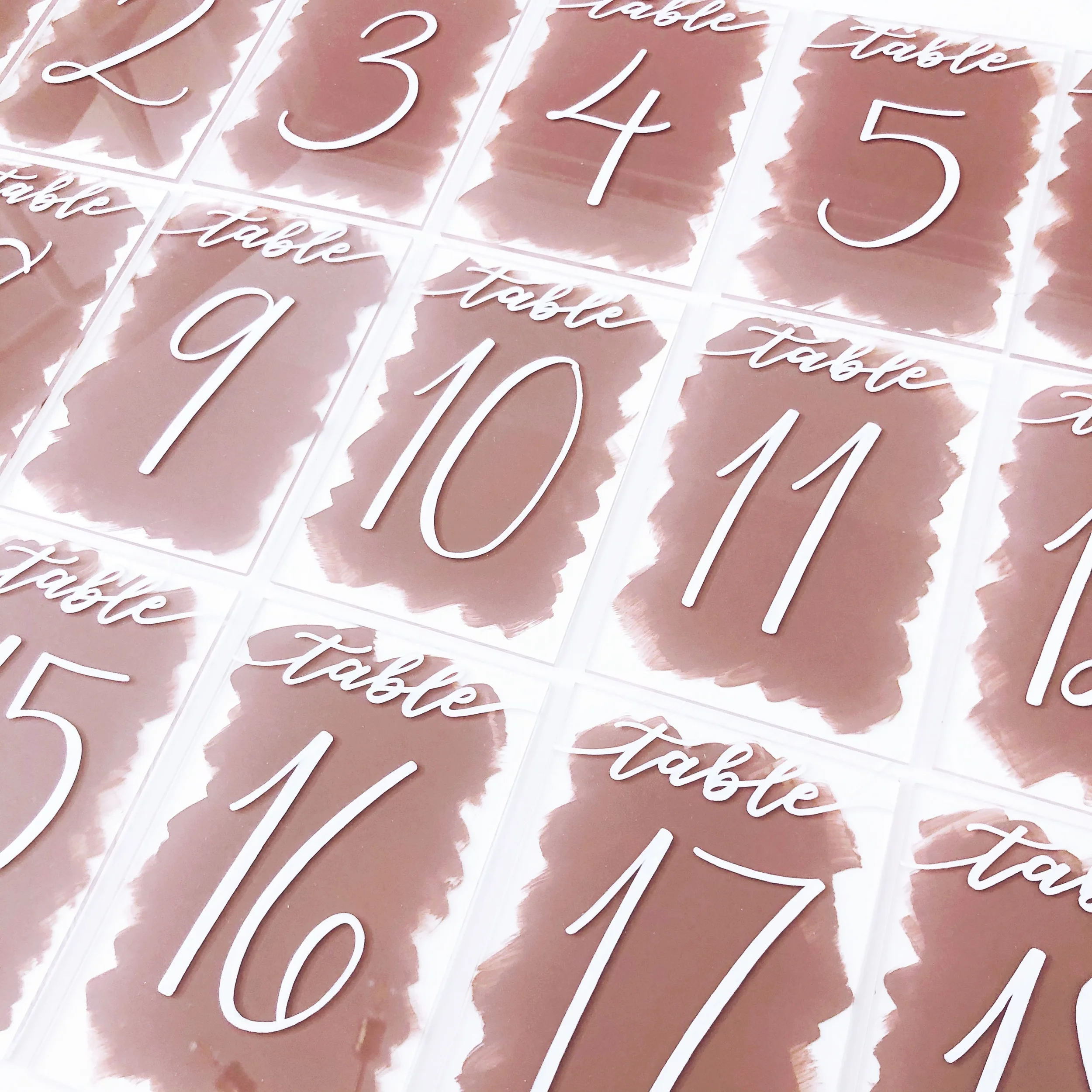 Bring contemporary color to your tablescapes with back-painted acrylic table numbers. The rich mauve or dusty rose painted background makes the crisp white numbers pop, creating modern lucite signs ideal for chic, romantic receptions.